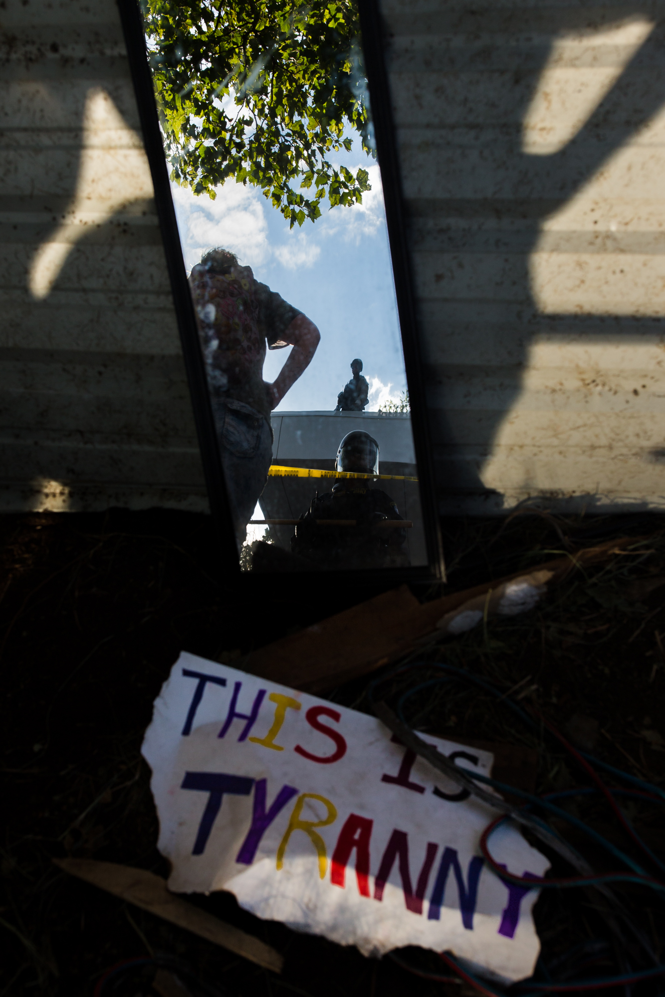  Portland police and Federal ICE agents are reflected during the Occupy ICE protest in Portland, Oregon, on June 28, 2018. 