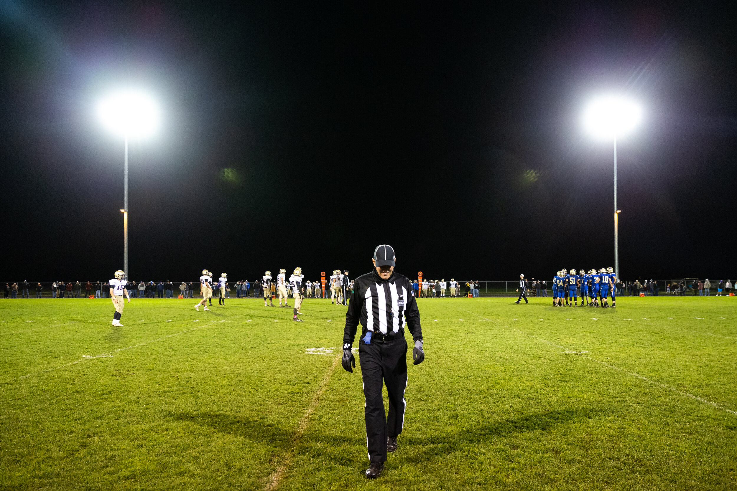  Eric Cheatley, center, walks back to the sideline during Friday night's football game between Adna High School and Onalaska High School at Adna on Oct. 25, 2019. Much like the players, referees will work through difficult weather conditions in addit