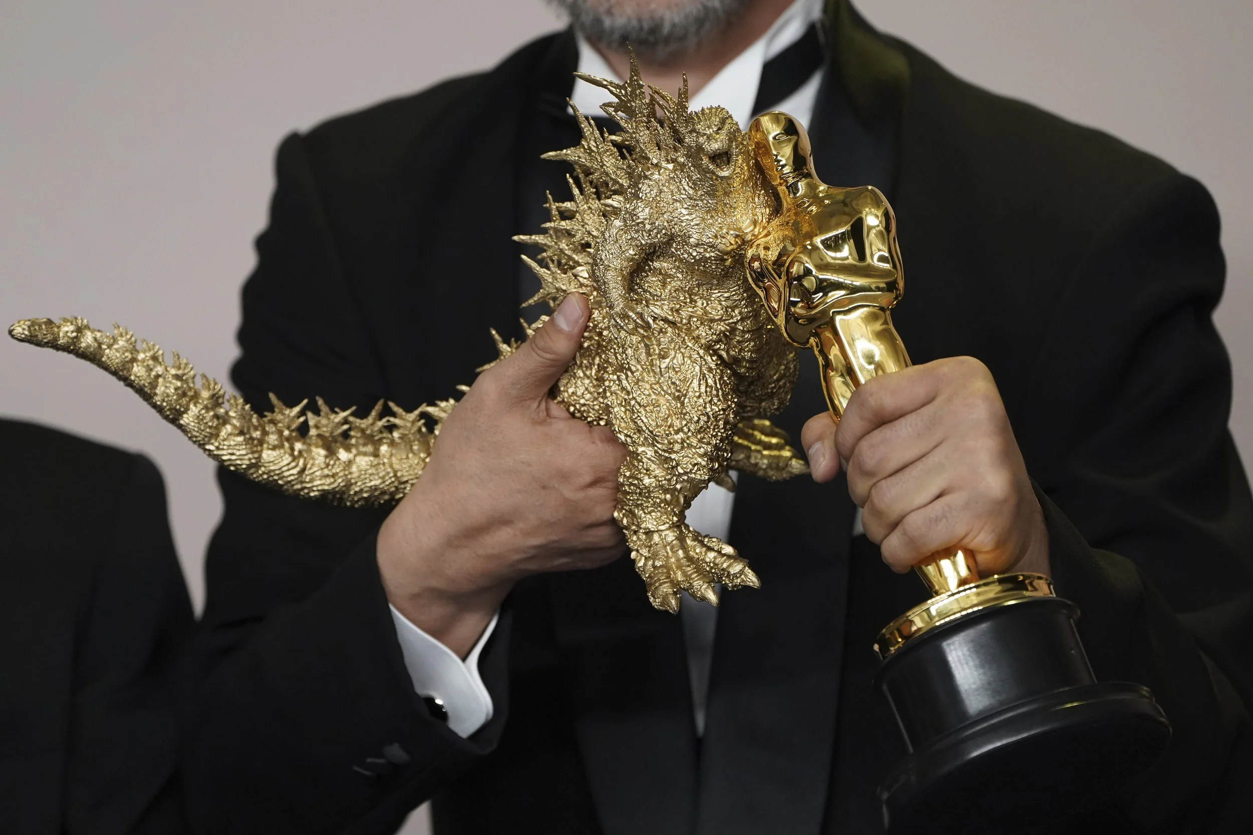  Takashi Yamazaki poses a Godzilla figurine with the award for best visual effects for "Godzilla Minus One" at the Oscars on Sunday, March 10, 2024, at the Dolby Theatre in Los Angeles. (Photo by Jordan Strauss/Invision/AP) 