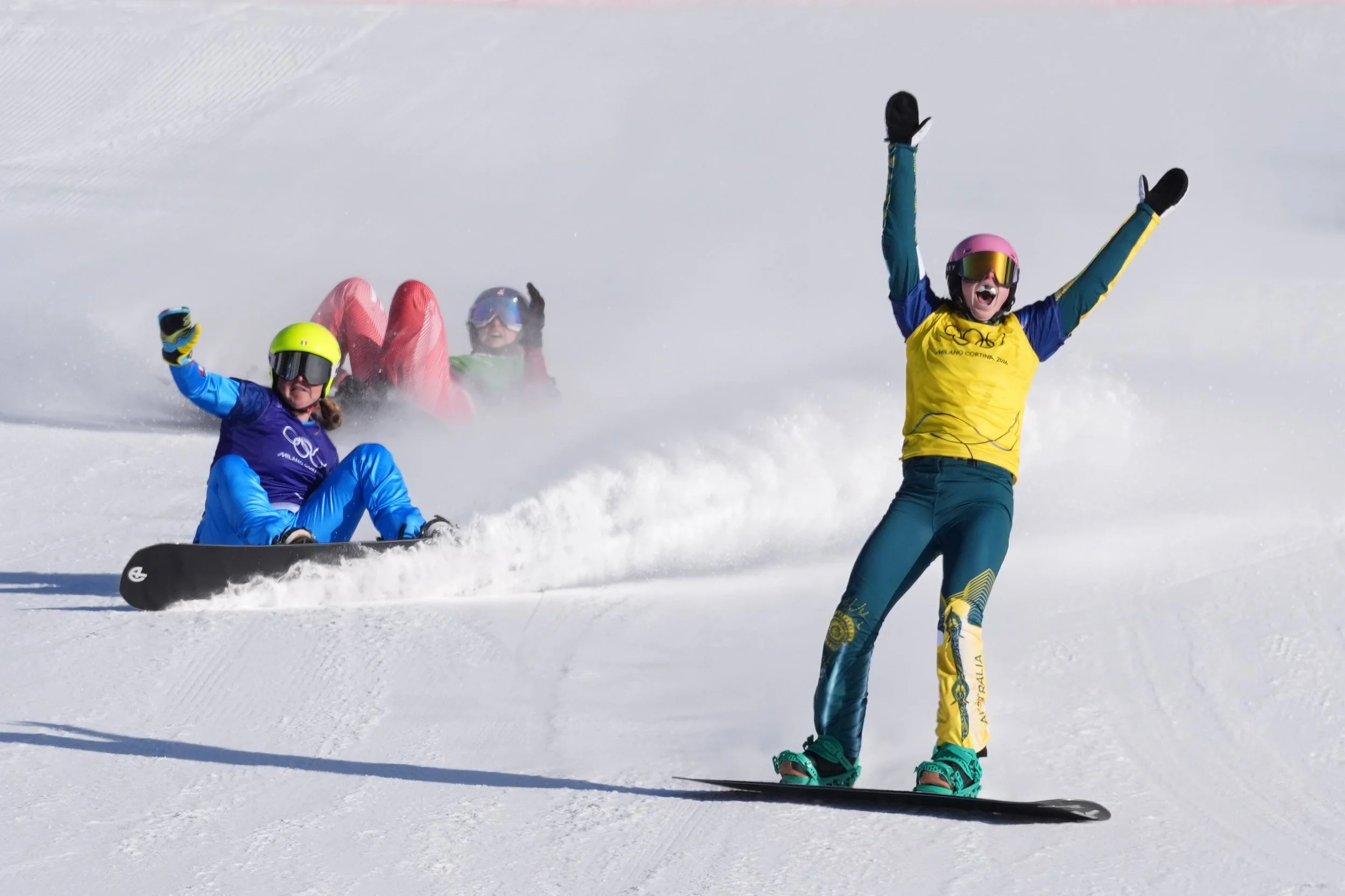  Australia's Josie Baff (17) celebrates her gold medal win past bronze medalist Italy's Michela Moioli (6) and Switzerland's Noemie Wiedmer (3) during the women's snowboard cross finals at the 2026 Winter Olympics, in Livigno, Italy, Friday, Feb. 13,