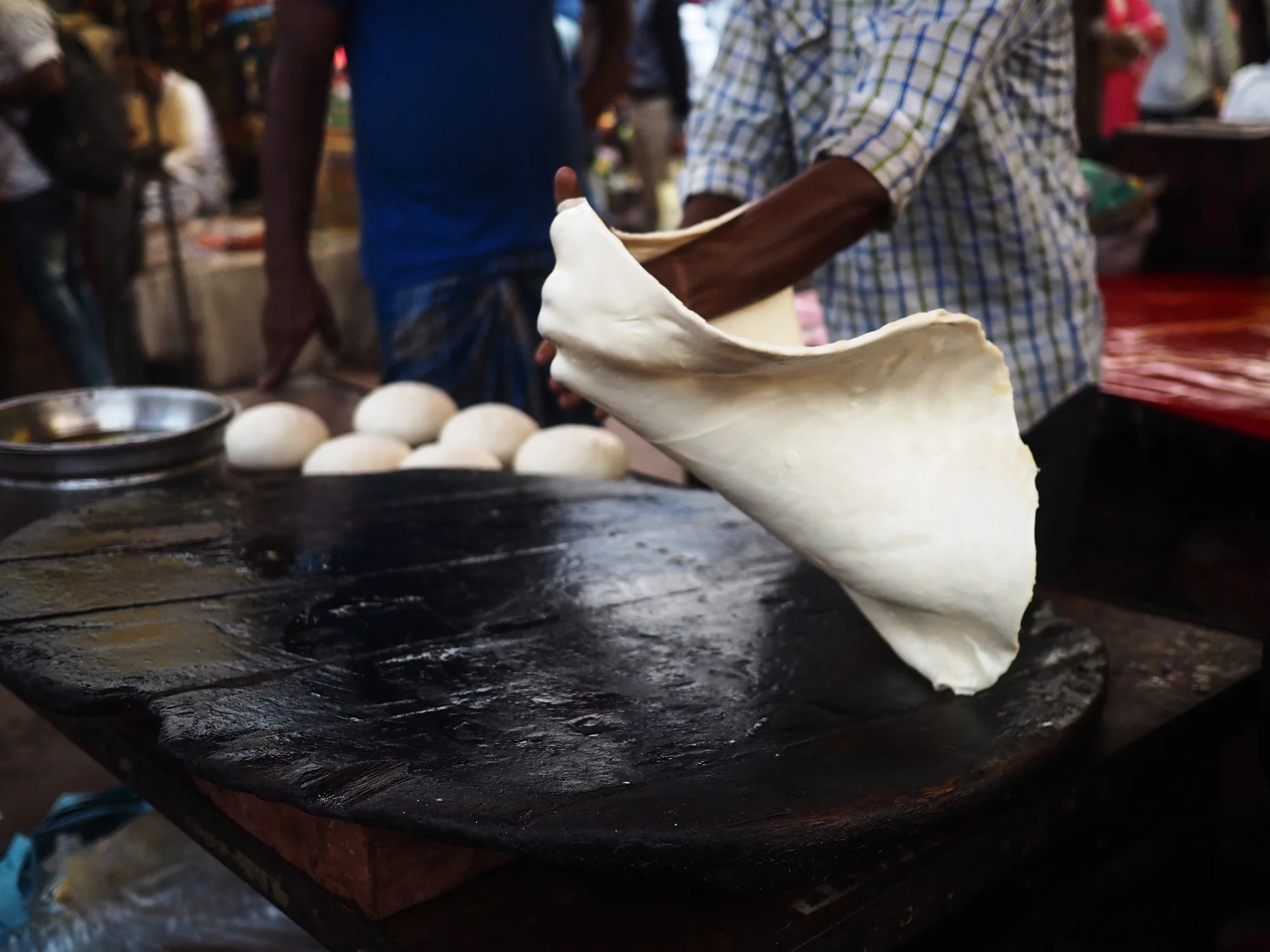 Preparing the enormous, fried, sweet rotis that are eaten with halwa.