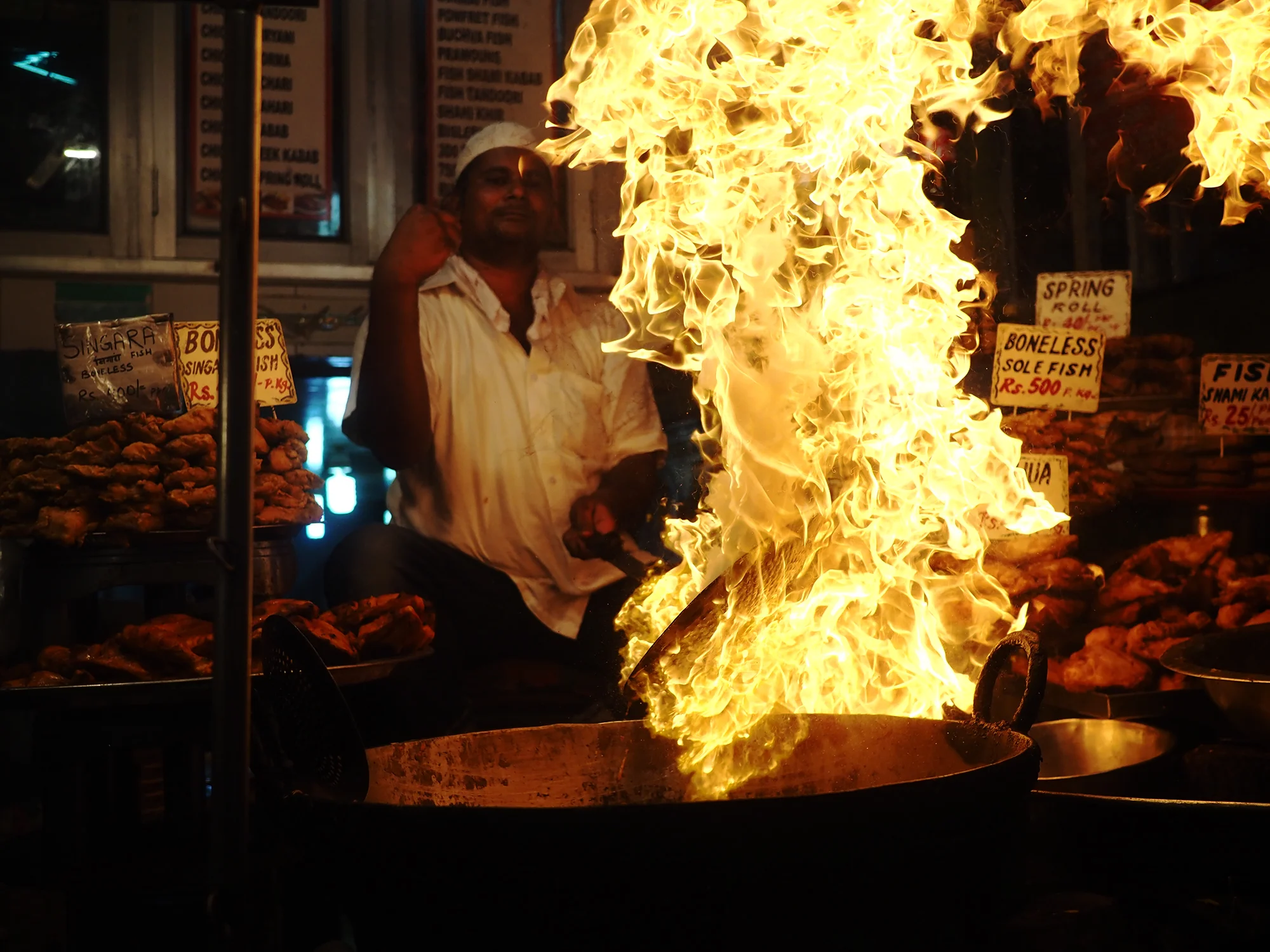 Firing up the kadais to fry kebabs.