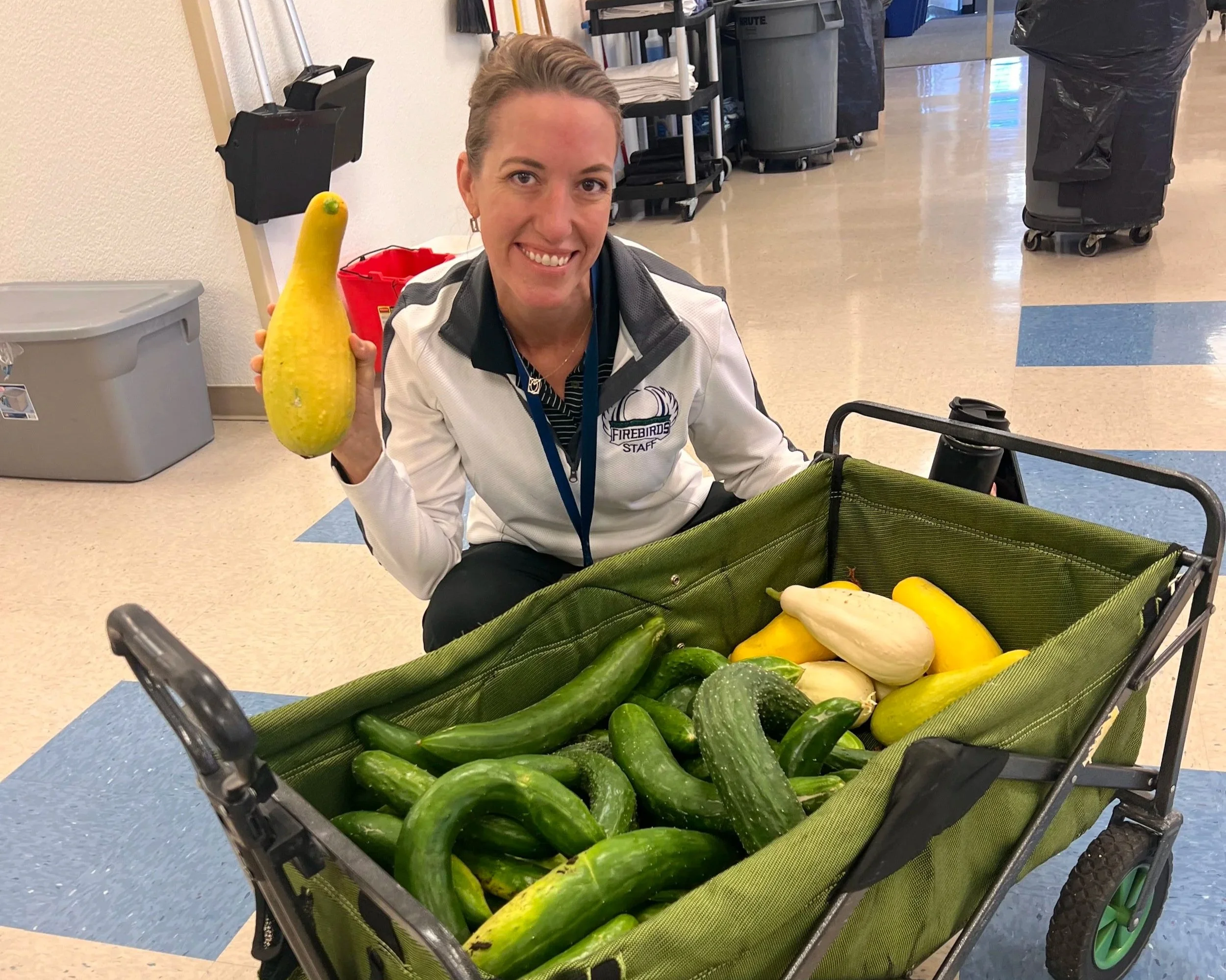 Ms. Ellis holding fresh produce from our garden