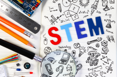 The word STEM with a variety of STEM-related items surrounding it, like pencils, rulers, a magnifying glass, etc.
