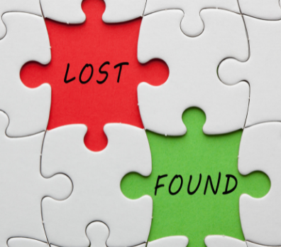 A red puzzle piece that says lost, and a green puzzle piece that says found, surrounded by white puzzle pieces.