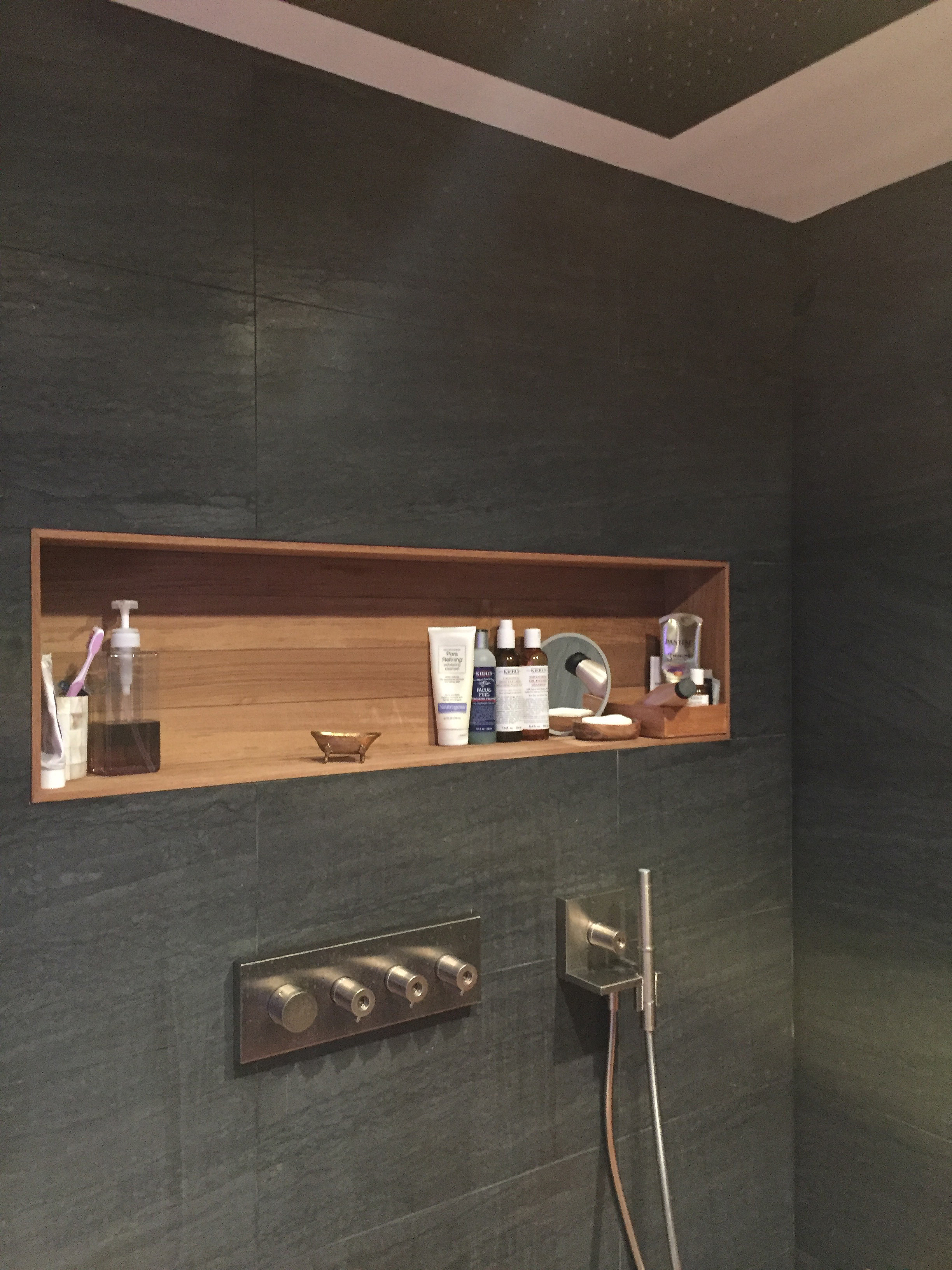 The same shower as above, here showing the Axor Starck Heaven ceiling mounted rain head and its many controls. Its a doozy. A teak wall nook holds all the soaps, complementing the teak shower floor and the brushed nickel fixtures.