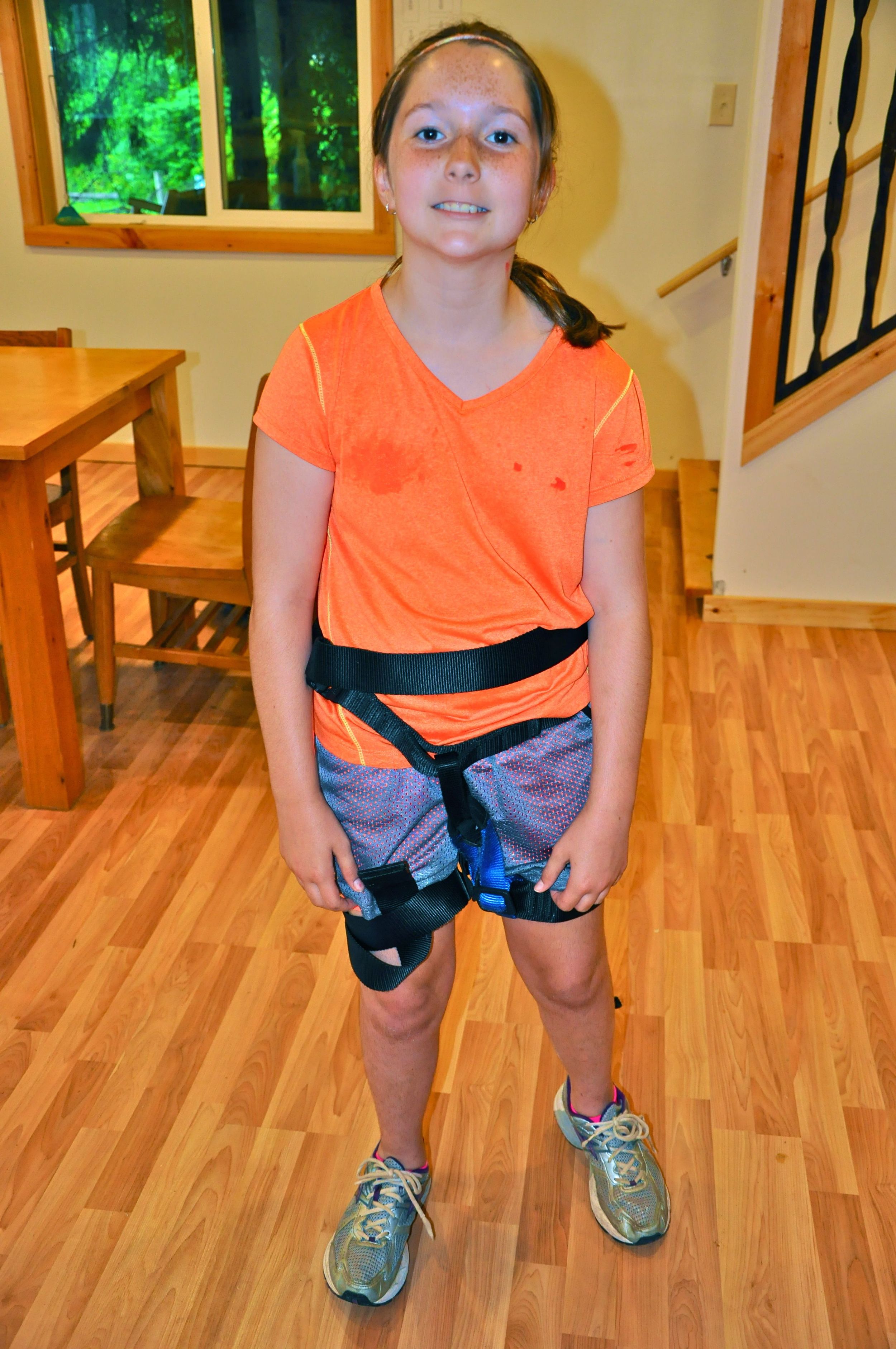 olivia-puts-on-climbing-gear-to-practice-for-the-climbing-wall.jpg