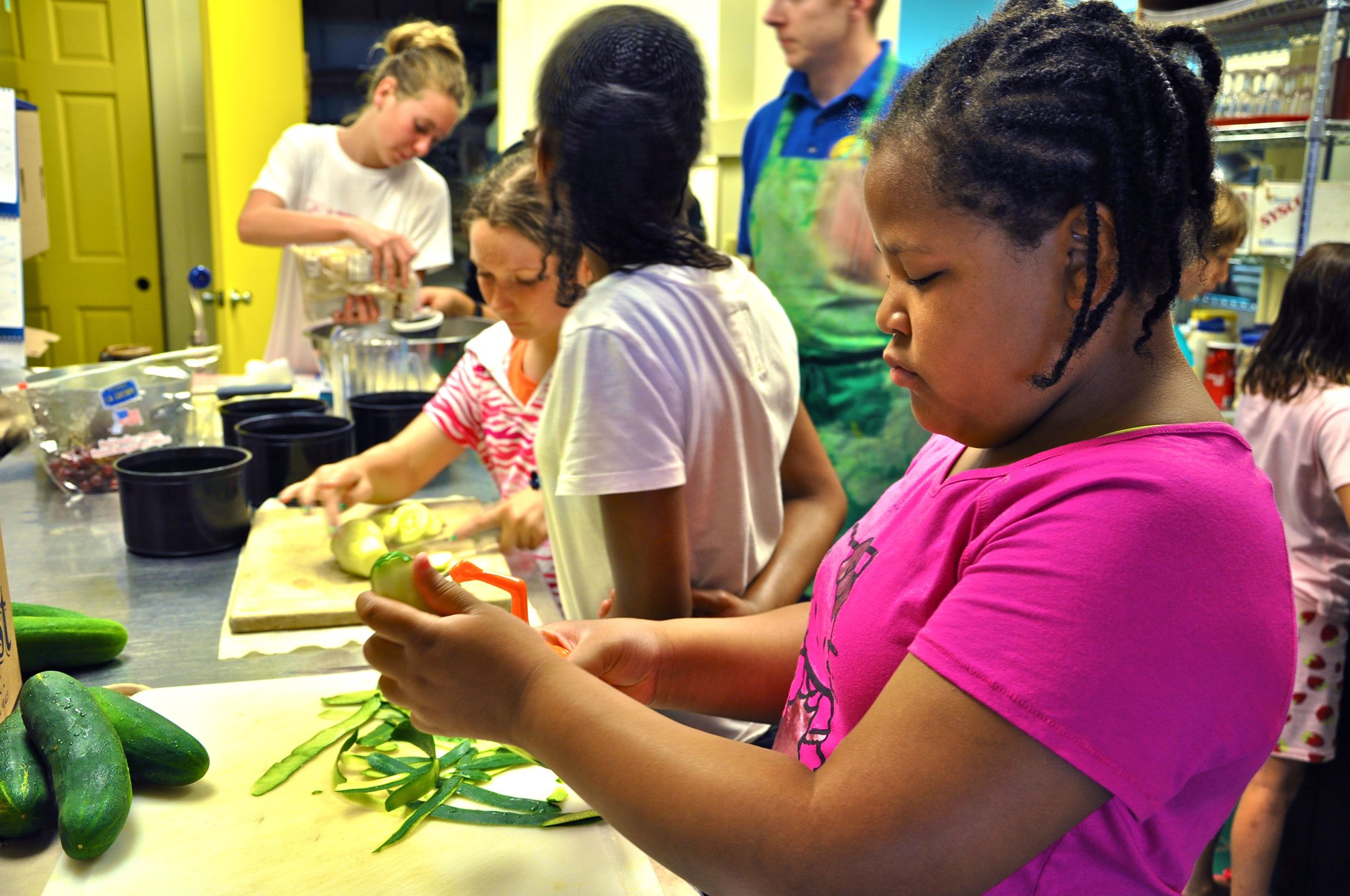 regianna-slices-some-cucumbers-for-the-salad-bar-she-really-enjoys-working-in-the-kitchen.jpg