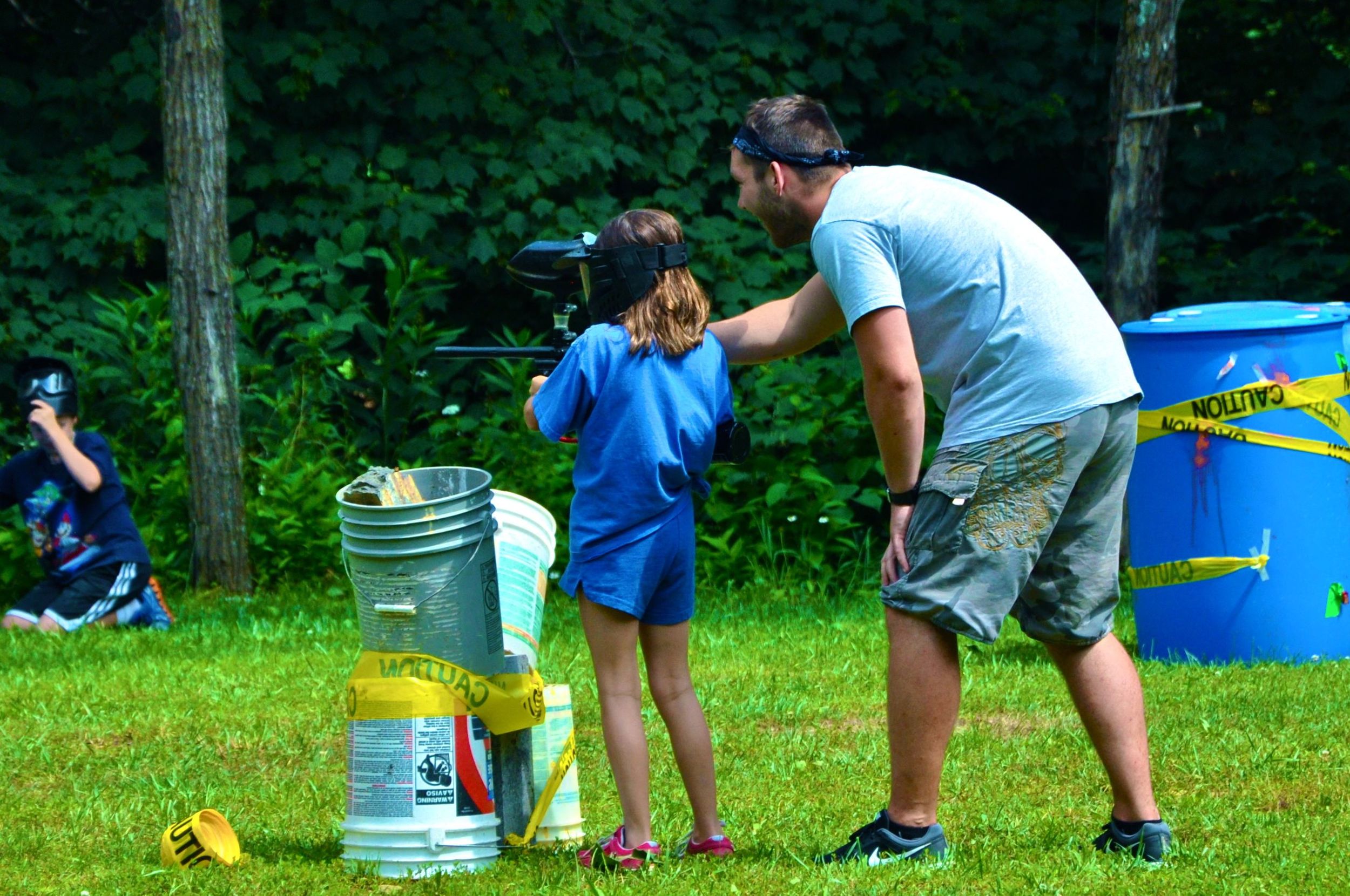 james-guides-morgan-with-how-to-operate-the-paintball-gun.jpg