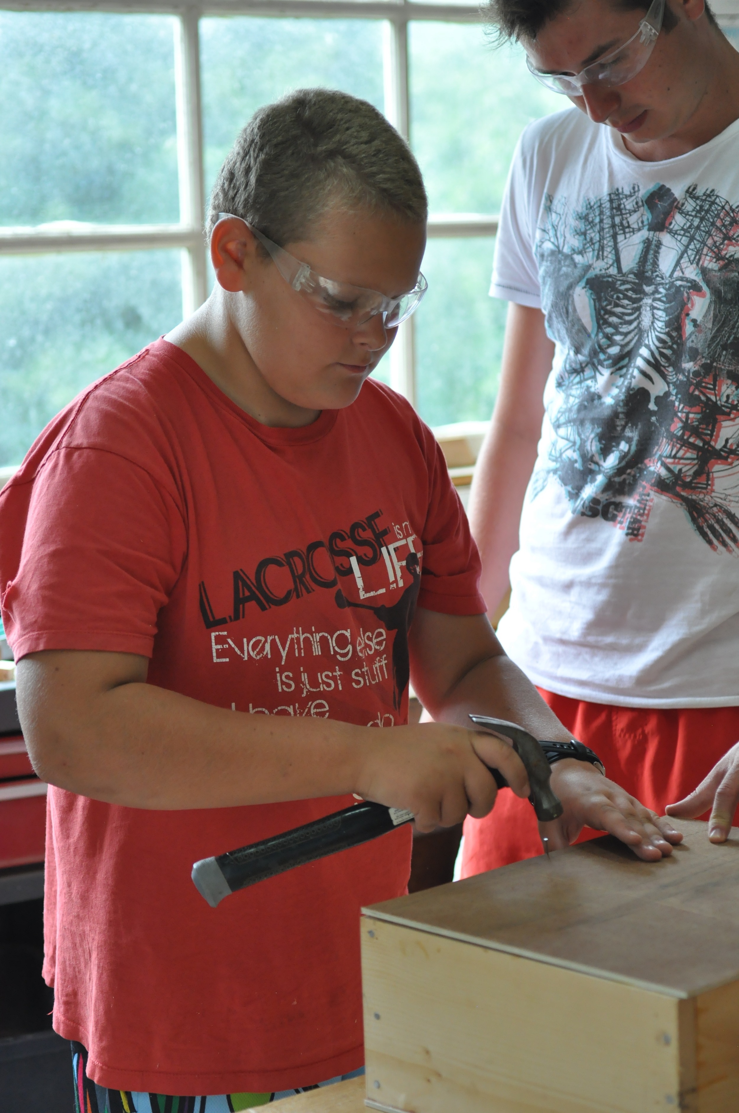 cole-is-hammering-away-at-his-box-in-woodshop.jpg