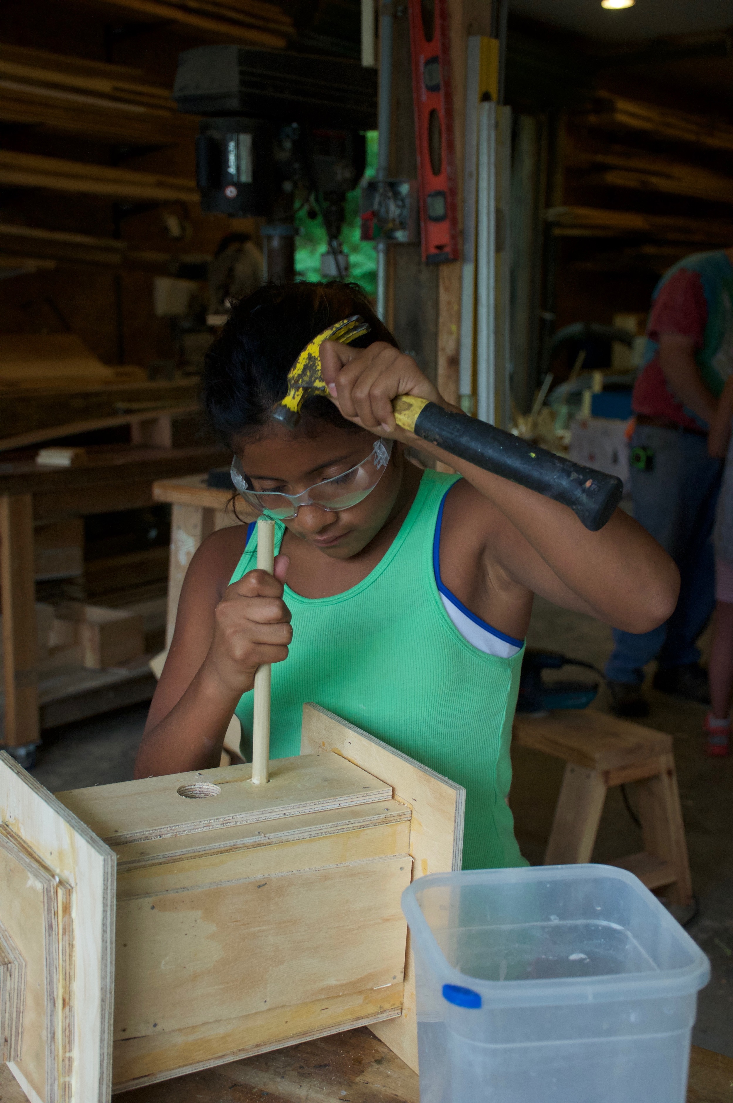C. is putting the finishing touches on her birdhouse.