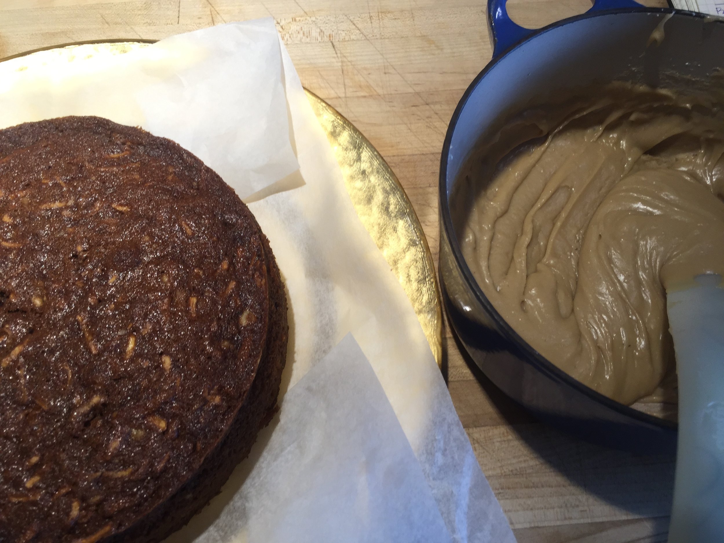 Cake and Icing ready to go. notice the parchment strips tucked under the cake (about 1" from the edge) to protect the serving plate.