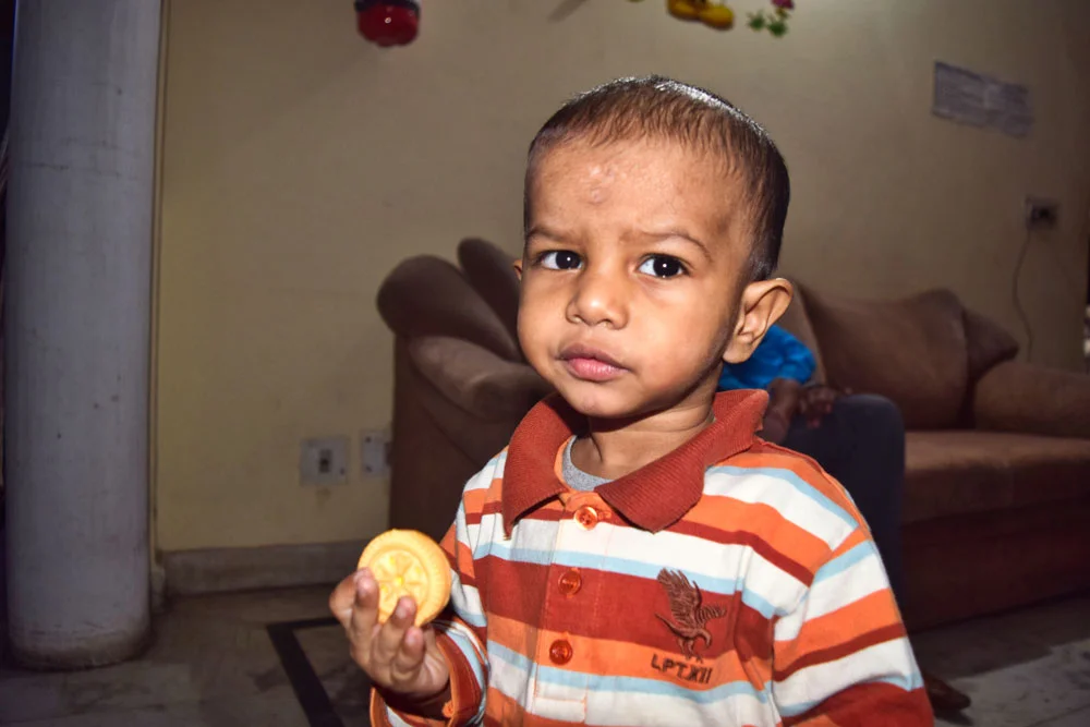His mother dropped him off at the police station and then suddenly collapsed. She was brutally attacked prior to dropping the child at the Police Department. The policy has not been able to find her attacker. No one has come forward to claim him or has reported him missing for 90 days. He has been adopted and is living happily with his new family in India.