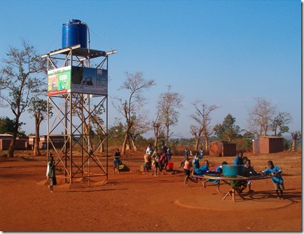 Children at a Playpump and the water storage tank