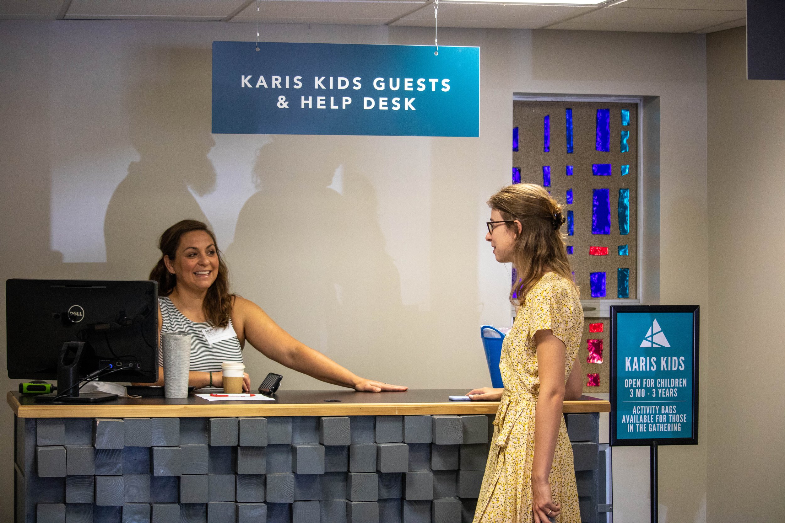 Karis Kids Director at the Check-In Desk