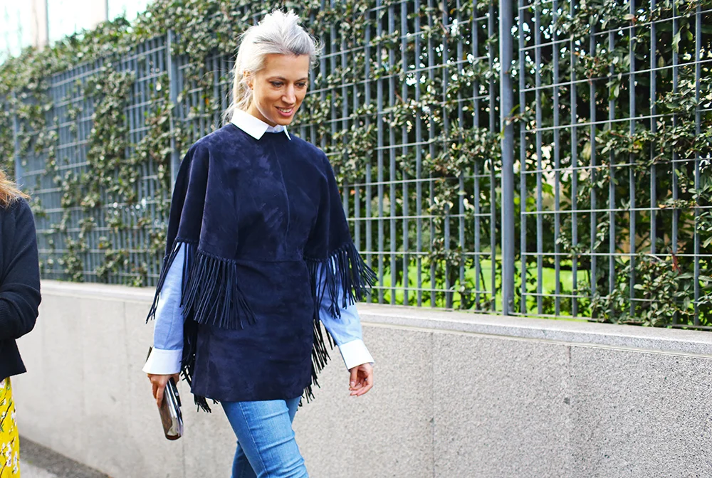 Sarah Harris , Fashion Features Director for British Vogue, in a fringed, navy, suede ponch
