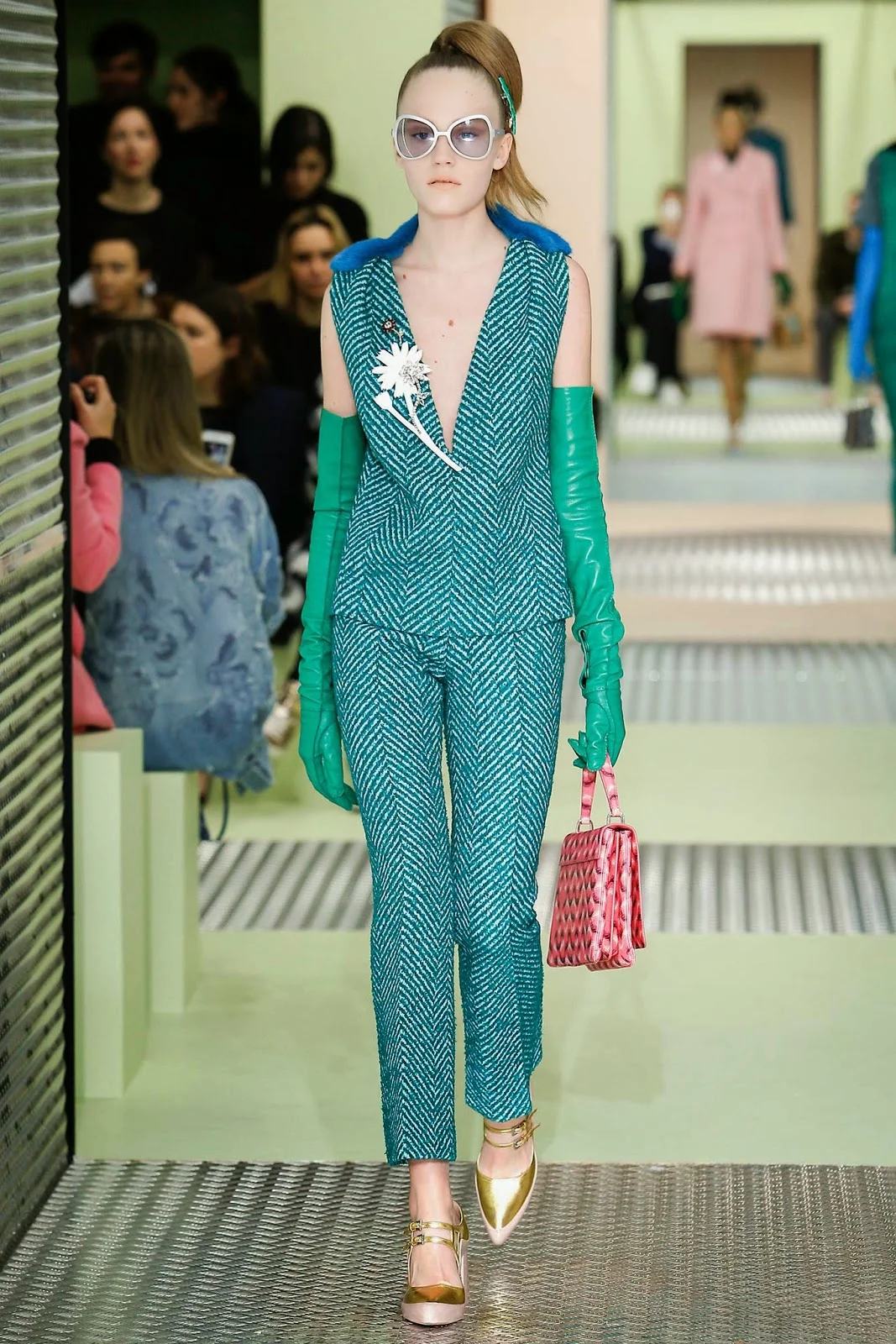 Bejeweled floral brooches served as statement pieces on the Prada FW 2015 runway