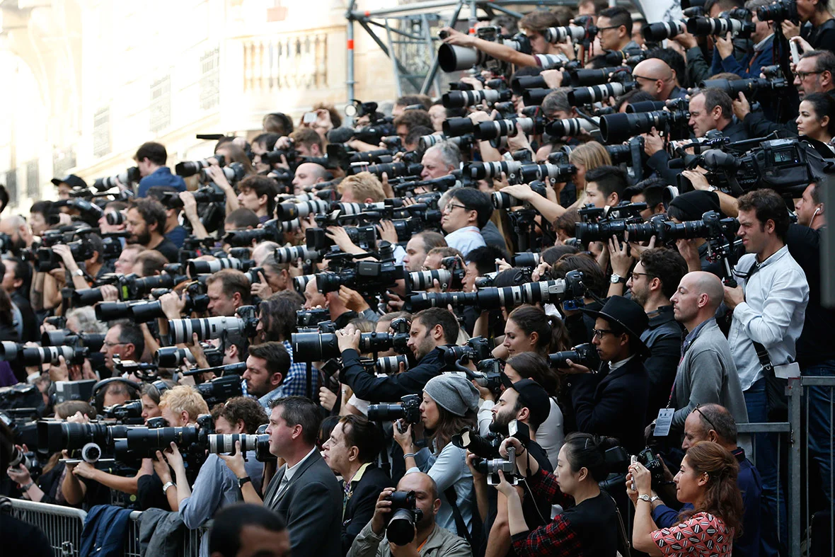 Photographers capturing and contributing to Fashion Week madness; image via