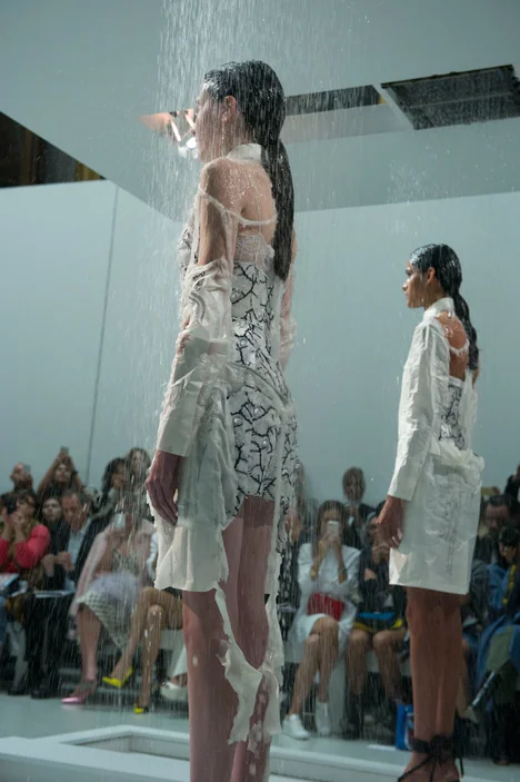 The ensemble's simple exterior disintegrated to reveal delicately embellished garments; image via