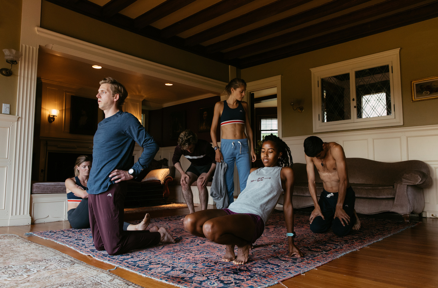 Tracksmith athletes feature the fall line as they finish a core and stretching session. 