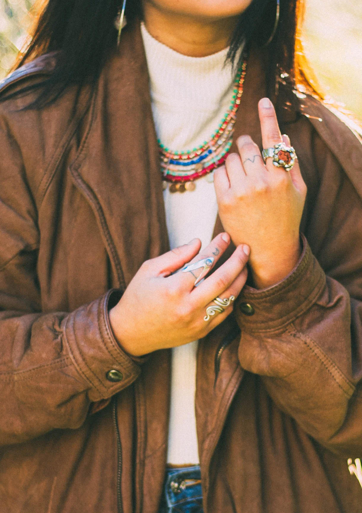 The gold necklace and earrings were handed down from my mom. The opal and silver rings were brought back from Ecuador. The leather jacket is a Village Discount find, brand: Z. Cavaricci.