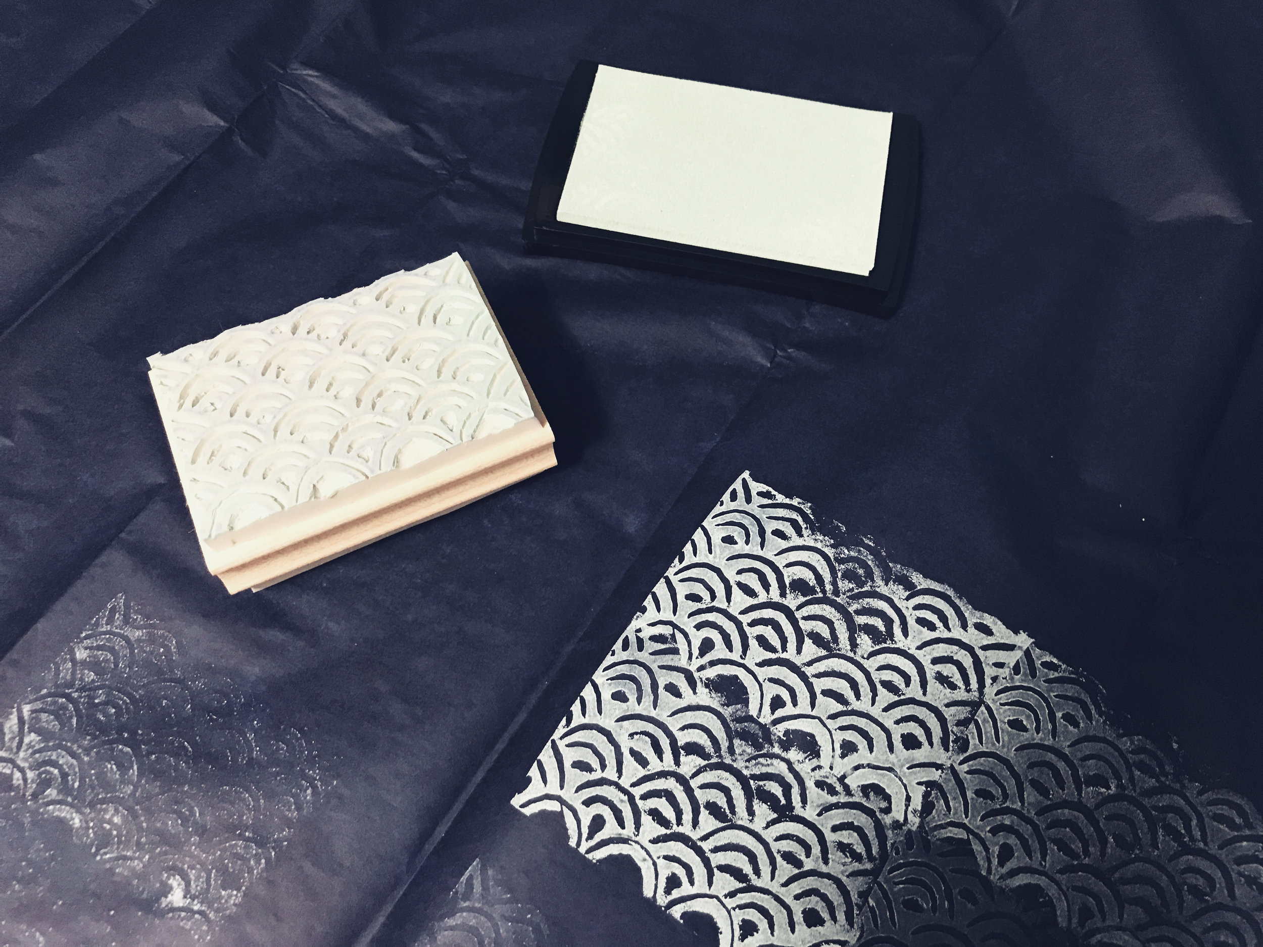 White ink first. Universal rule of ink and paint: start with light colors and work up to the dark ones.