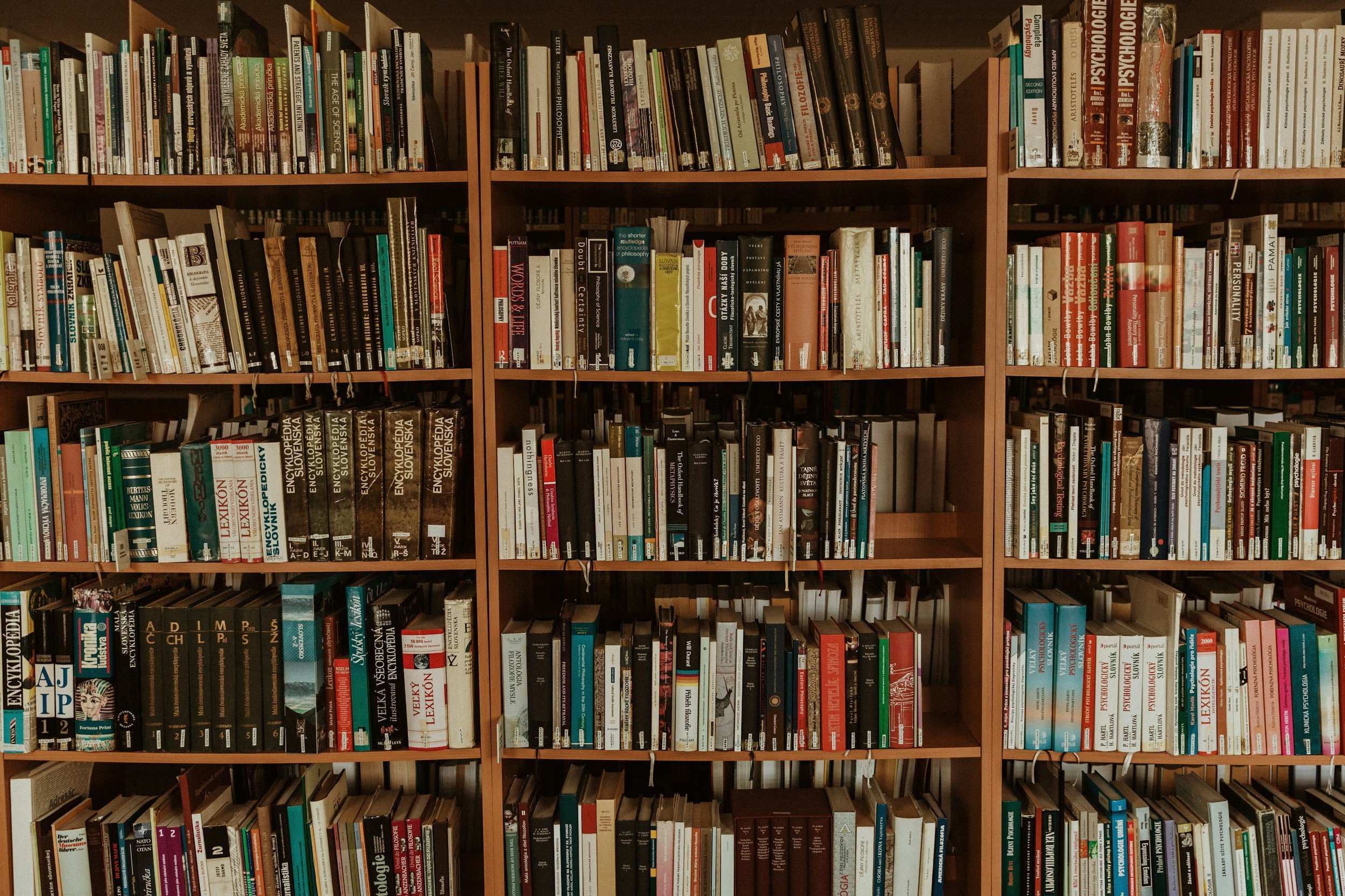 Large library bookshelf filled with books arranged across multiple shelves.