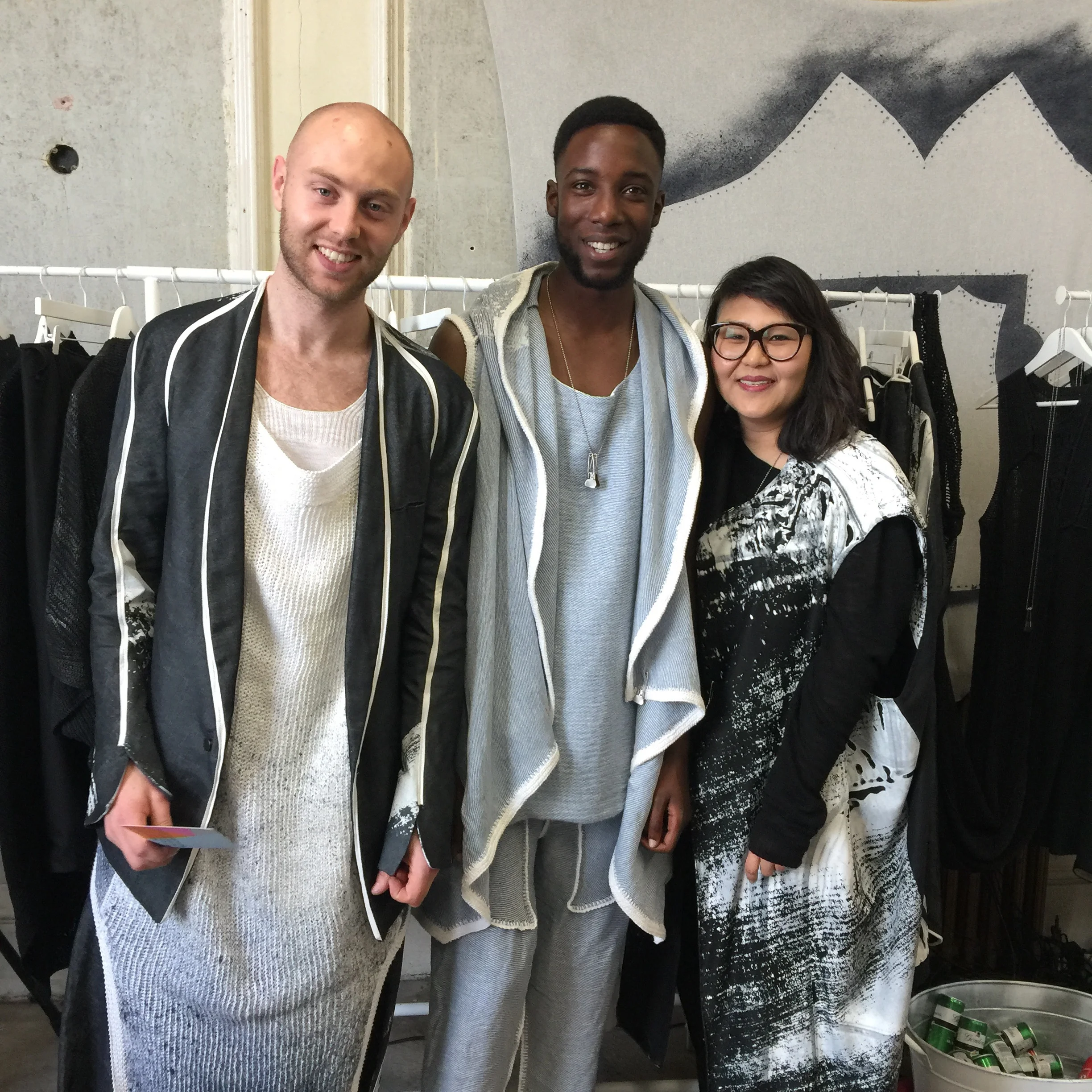 Miles Dunphy and Elsa Ellies on either side of their friend and house model, all wearing their own designs