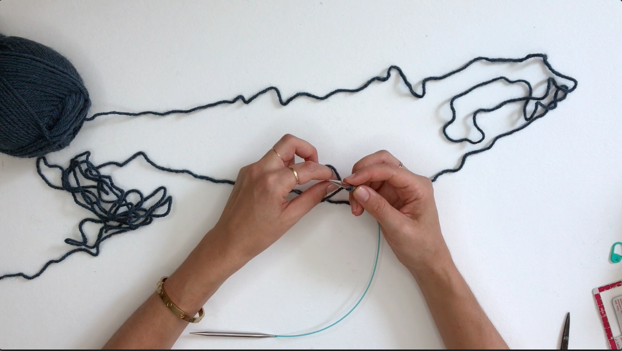 Insert finger between yarn.