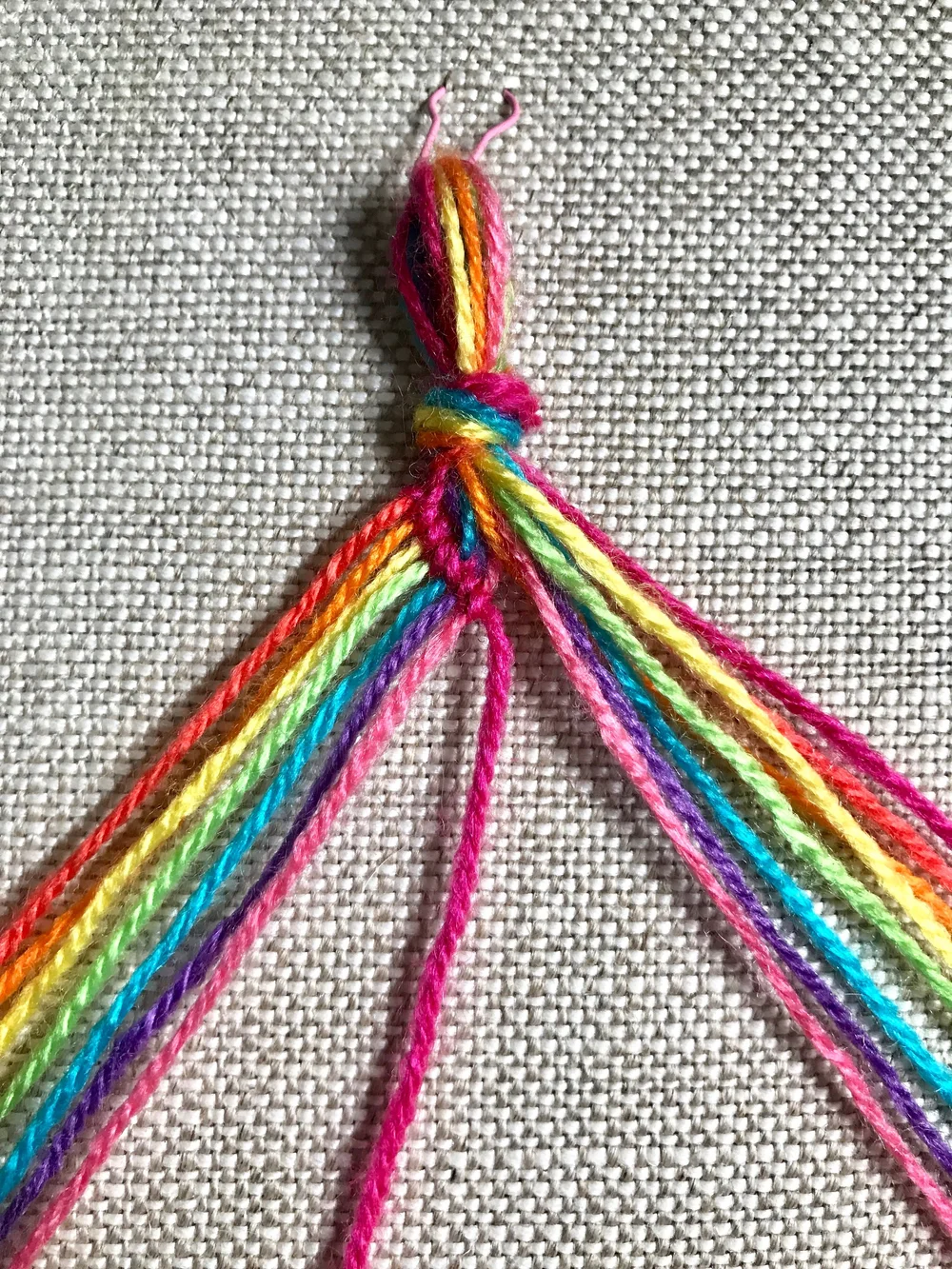 7. Repeat these steps, working a  forward knot  with the working thread on each thread in the left group. Try to work each forward knot slightly diagonally down to the right to begin forming the chevron design. It will be a bit finicky at first, but after a couple rows the shape will be established and it will be much easier.