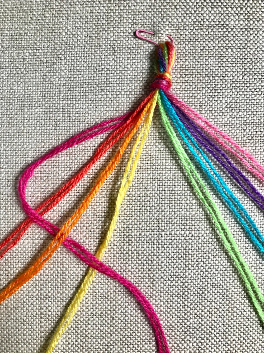 3. Working left to right, weave the left most thread OVER, UNDER, OVER the next three threads.