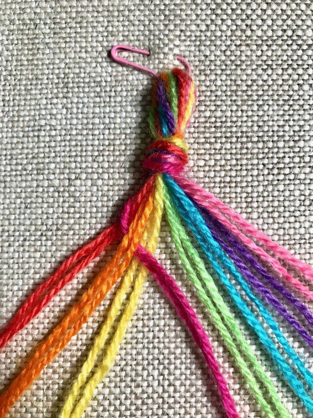 4. Pull this thread up to tighten the weave. The thread just used now joins the right group, leaving three on the left and 5 on the right.