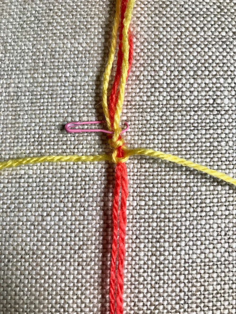 6. Tighten the knot all the way and draw it up to the top of the work. Half of the square knot is now complete.