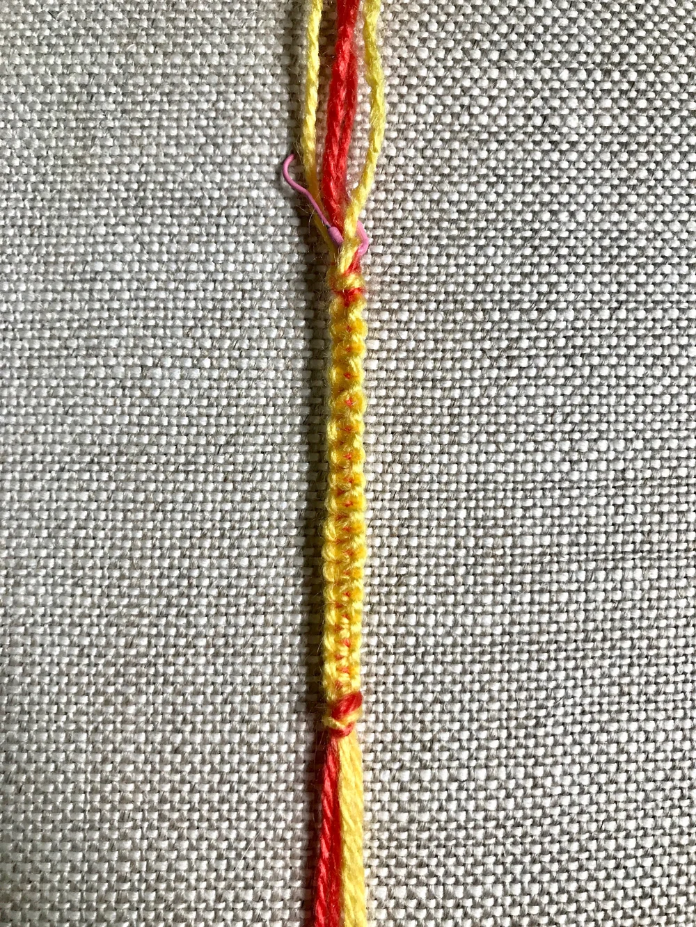 11. Tie a knot with all threads at the bottom of the square knots to match the knot at the top.
