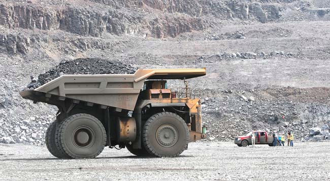 A truck carrying more than 240 tons of taconite ore takes a load to the crusher in the Thunderbird Mine of United Taconite near Virginia, Minn., on Aug. 7, 2014. (Forum News Service: Bob King)