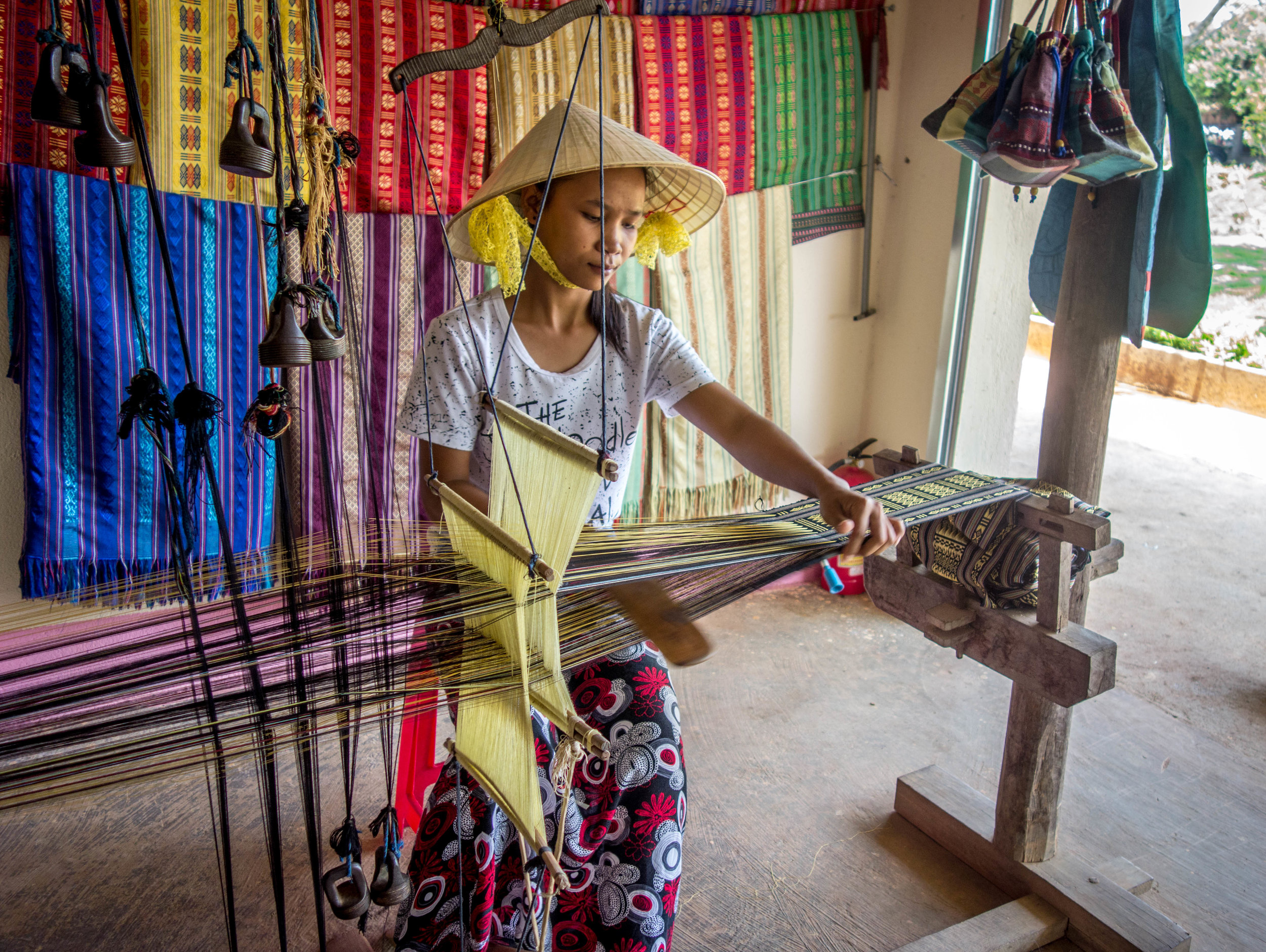 Woman performing traditional weaving techniques of the central highlands.