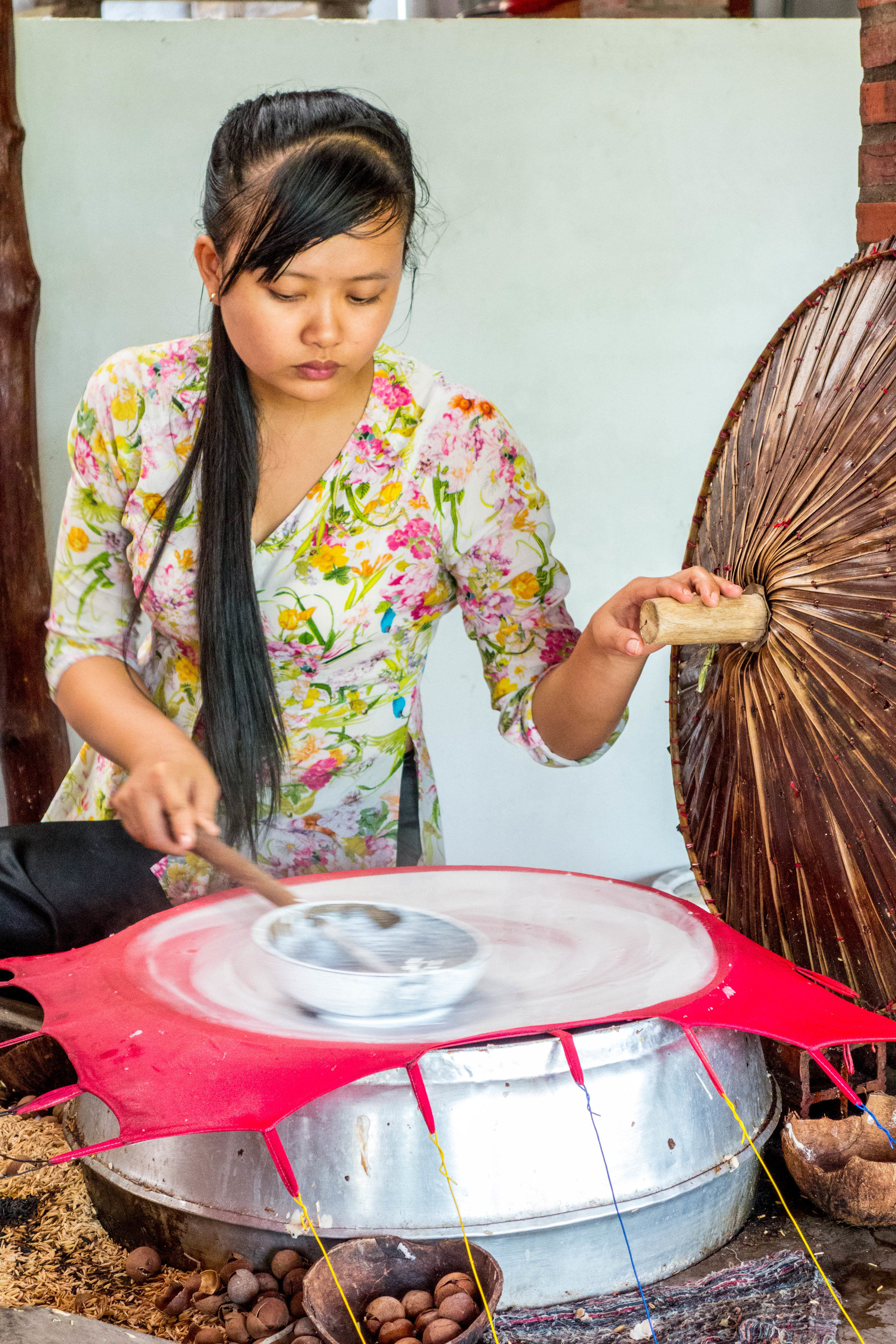 A young woman making rice paper.