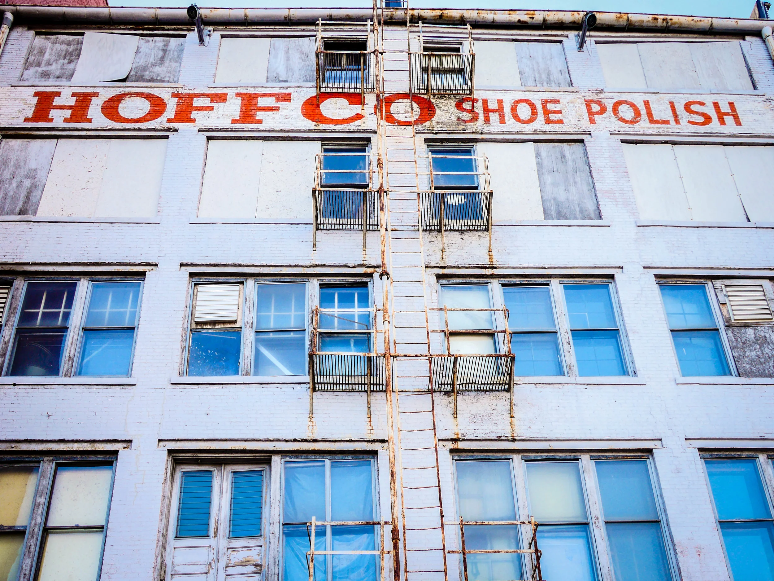Industrial buildings of a bygone era line the river walk, though Hoffo Shoe Polish is still in operation.
