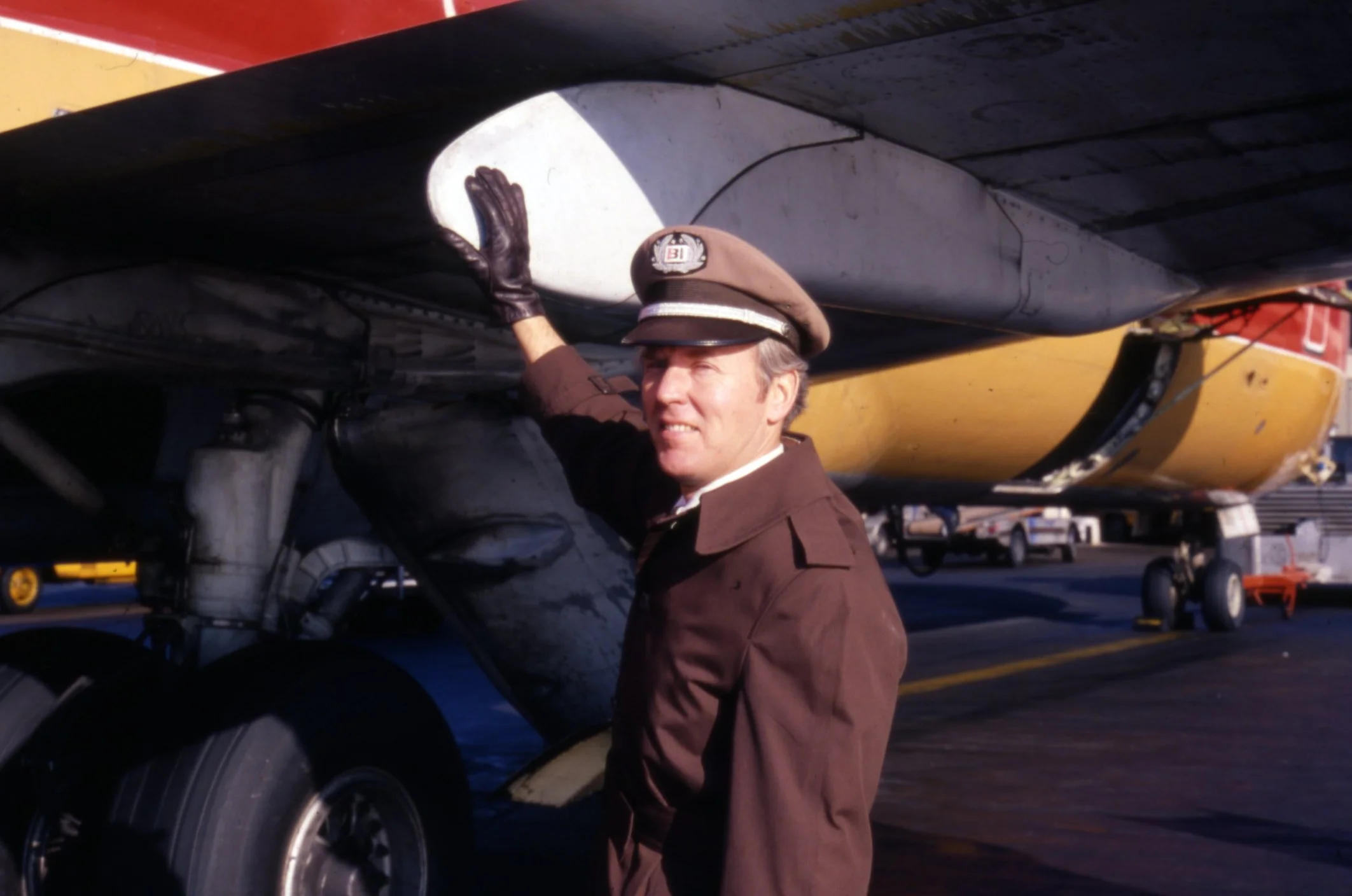 Braniff International Pilot Performing Walk-Around Inspection on Boeing 727 at DFW Airport, Texas