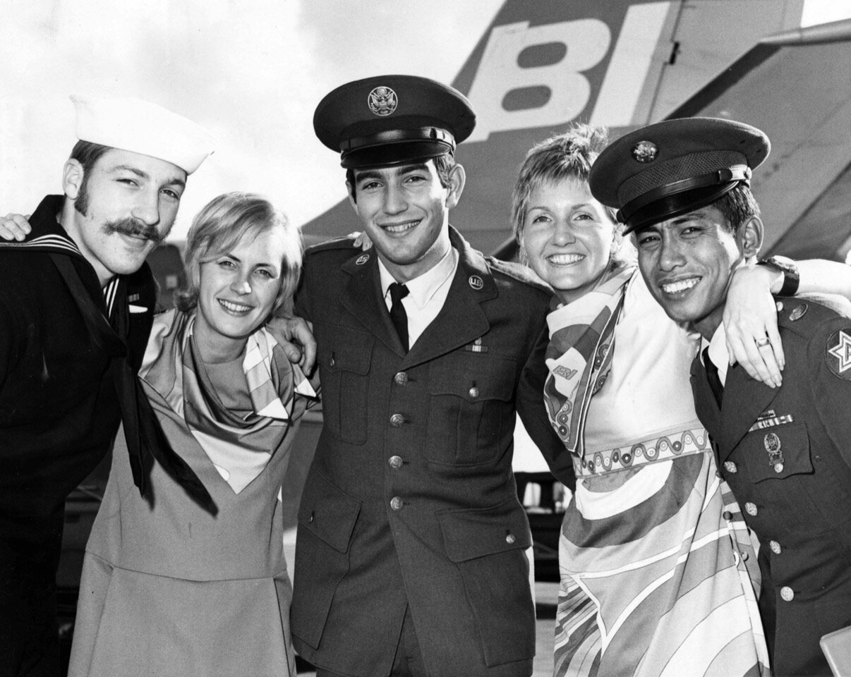 Soldiers arriving home from The Philippines are greeted by Braniff Hostesses in 1971