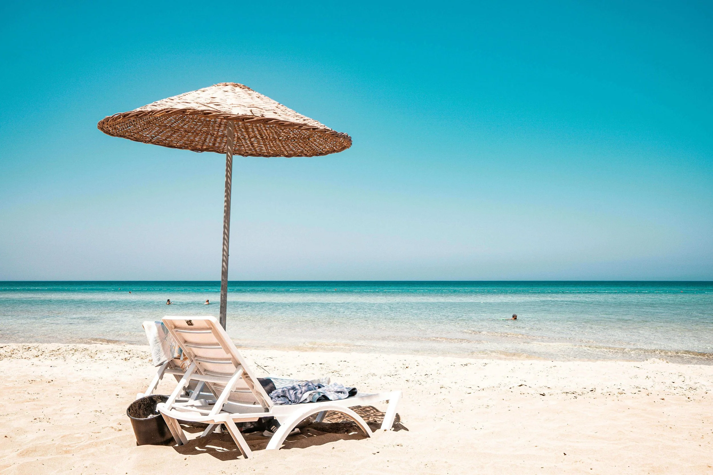 Relaxing chair under umbrella on Cape Cod beach during summer season