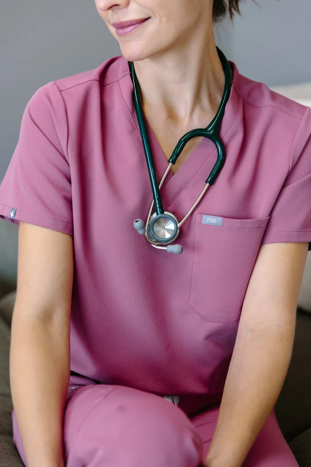Close-up of Jamie Mueller wearing pink scrubs with a stethoscope around her neck.