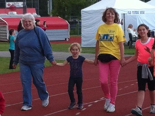 Millie celebrating surviving stomach cancer with her family at the Relay for Life
