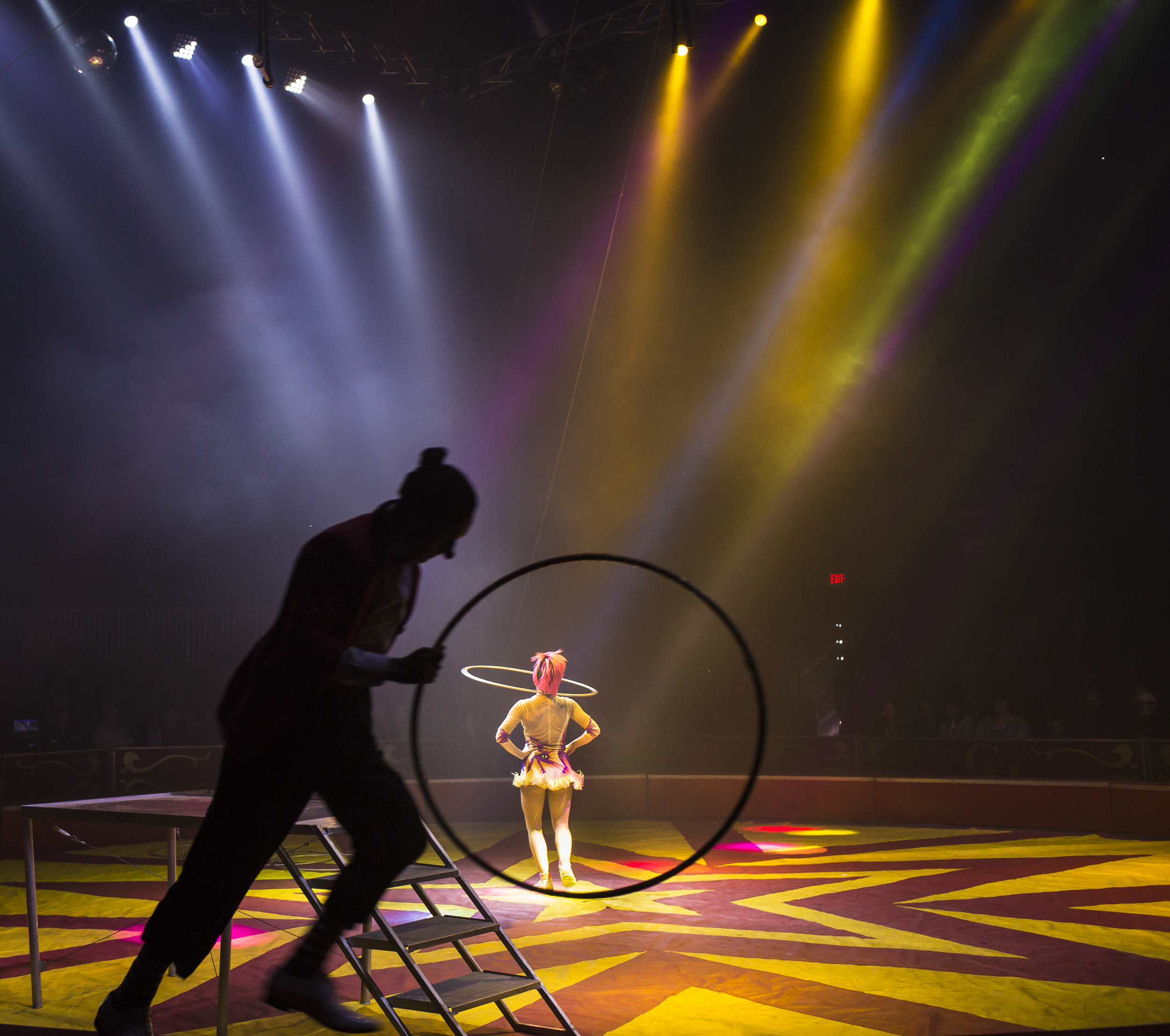 Crystal Coronas performs her opening hula hoop act as Cristhian Videla runs along the ring edge during a Coronas of Hollywood circus show at The Great New York State Fair in Syracuse, NY, Sept. 3, 2017.