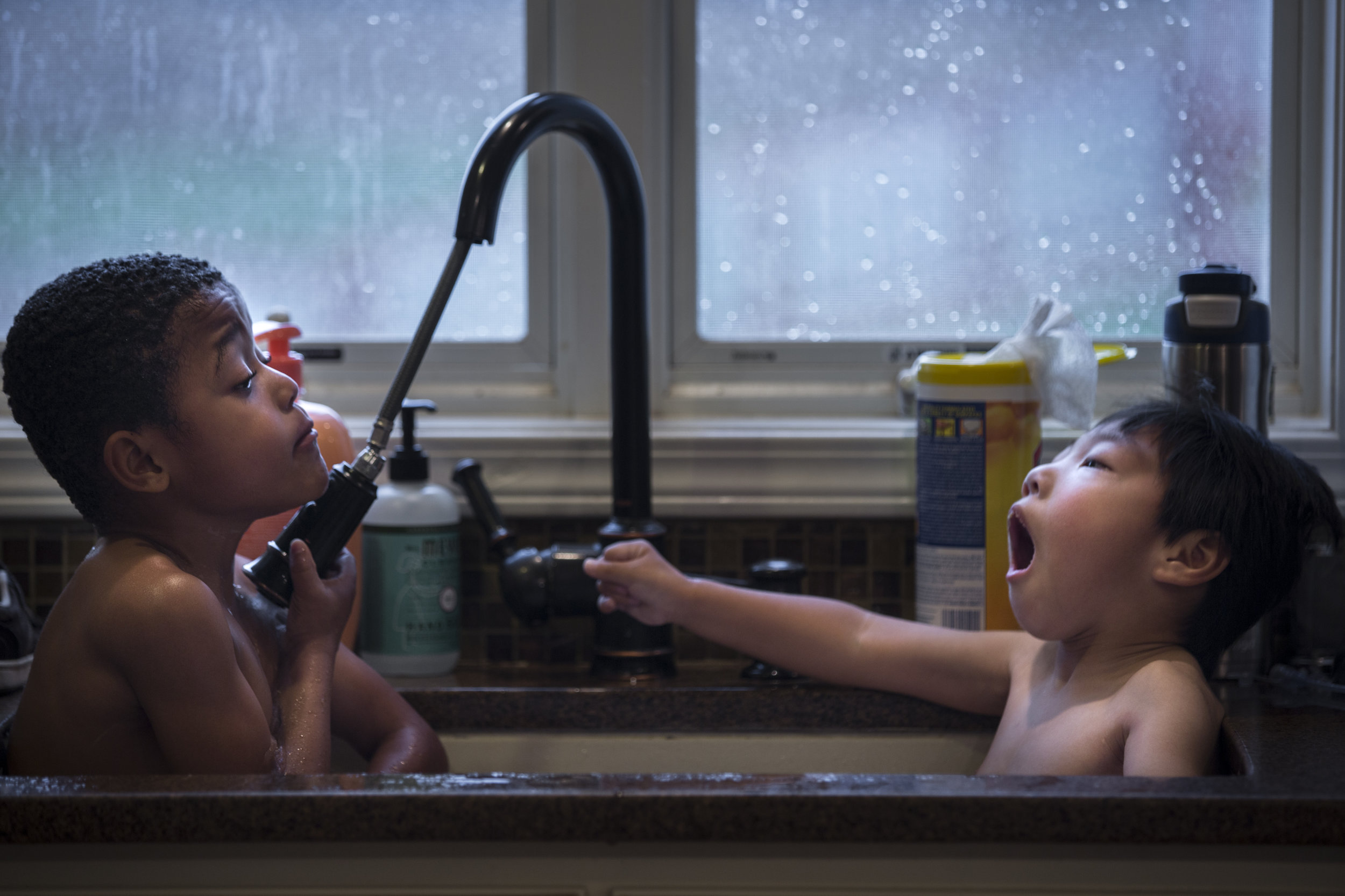  Caulder (5) and Graham (3) bathe together in the kitchen sink. Nov. 19, 2017 