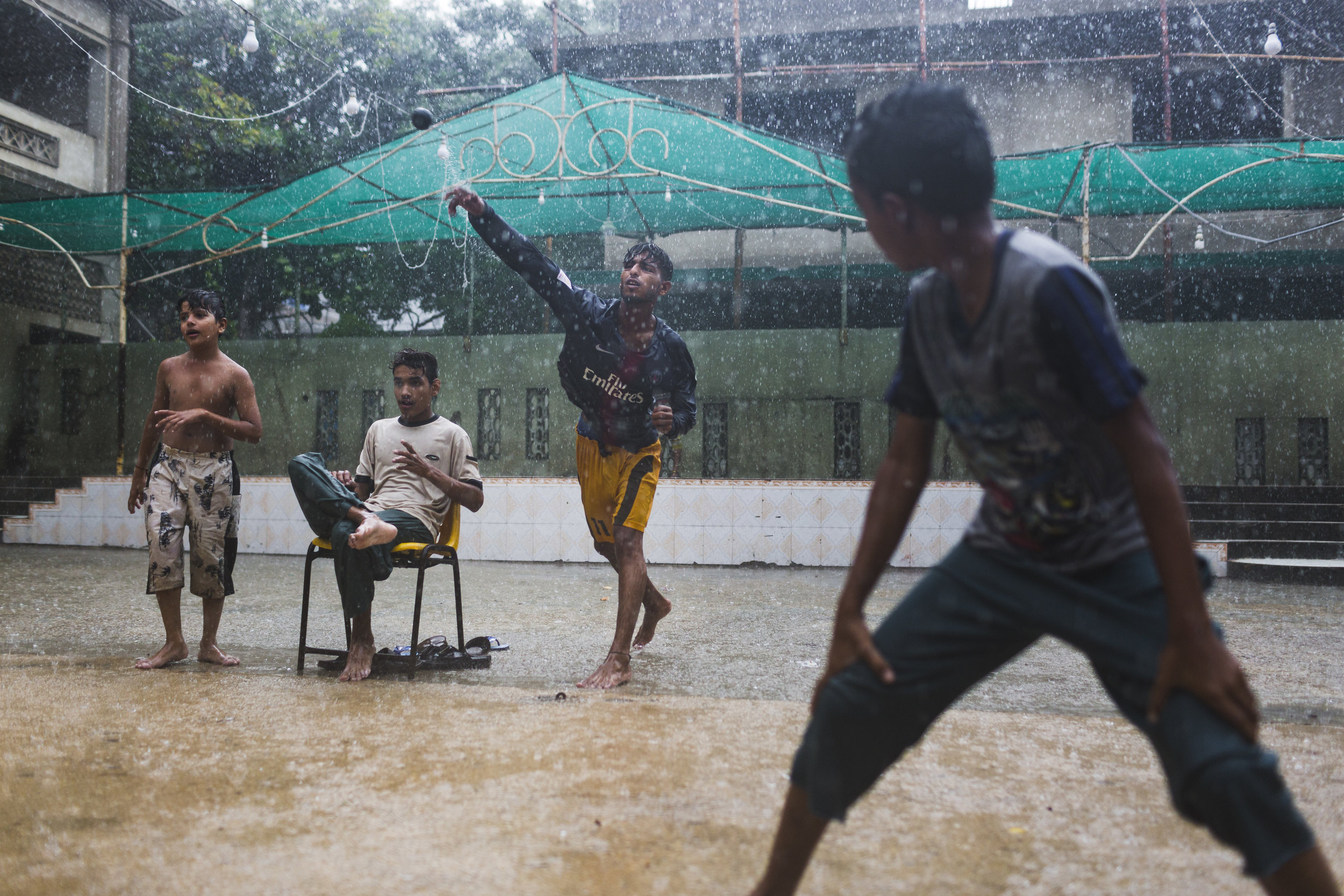  A group of boys play cricket during a torrential rainstorm in the neighborhood of Lyari, in Karachi, Pakistan on July 30, 2019.  