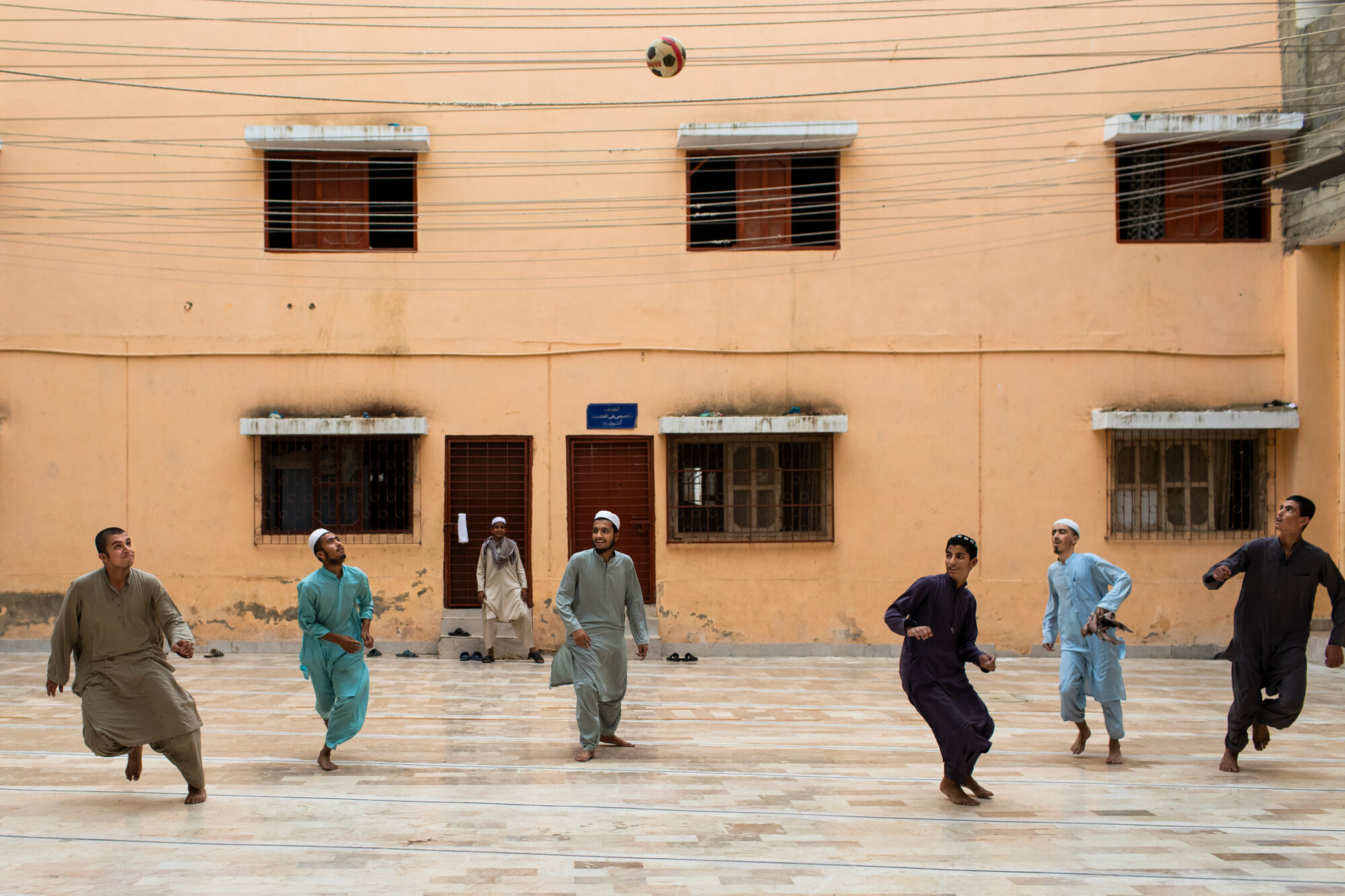  Students play football in the courtyard after their examinations. 