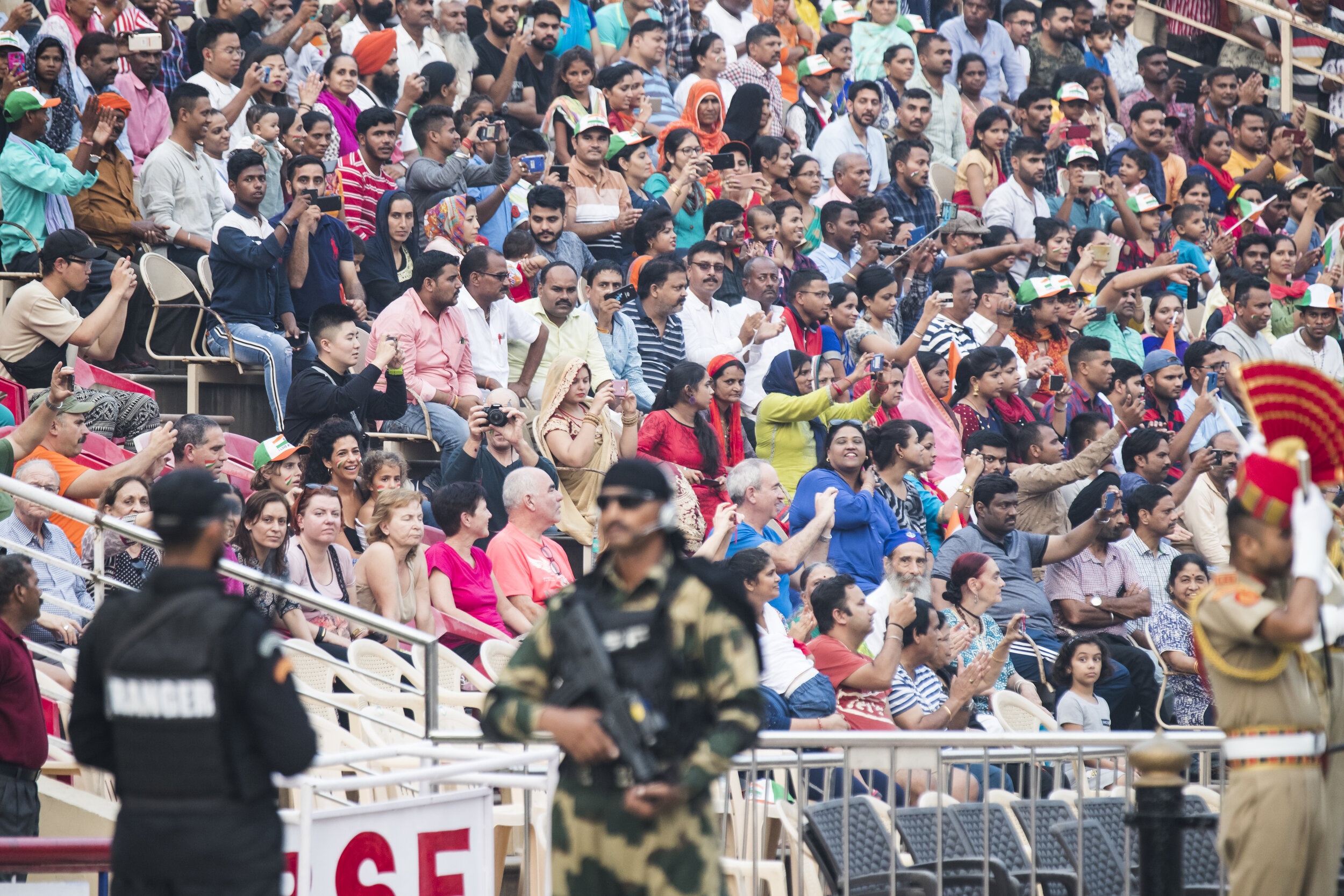  Indian fans watch the flag lowering ceremony at the Wagah-Attari border between Pakistan and India in Lahore, Pakistan on Friday Sept 27, 2019. 