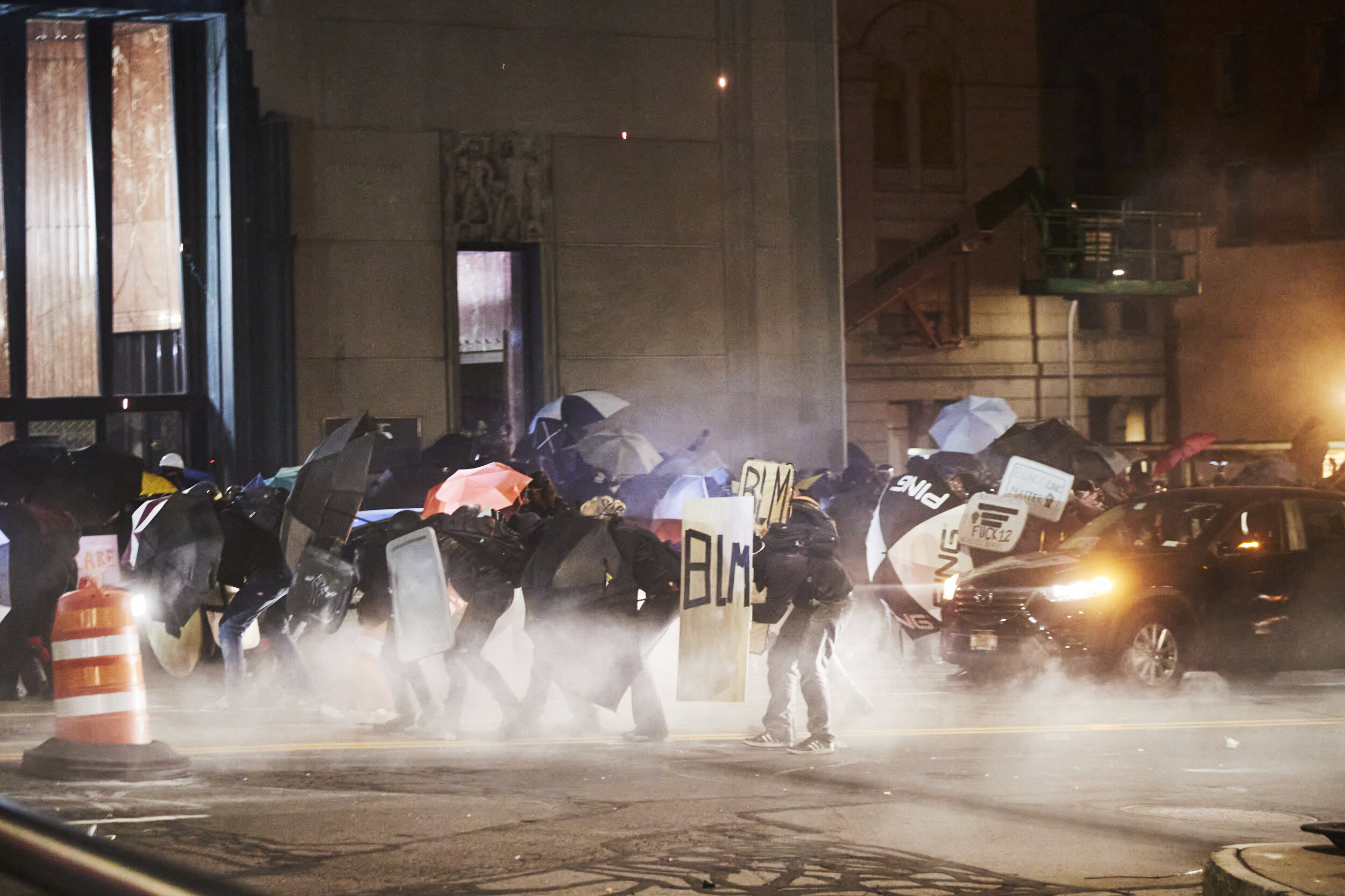  ROCHESTER, N.Y. - Sept 5, 2020: Frontline protestors with homemade shields and umbrellas are fired upon by police with pepper bullets and tear gas canisters.  