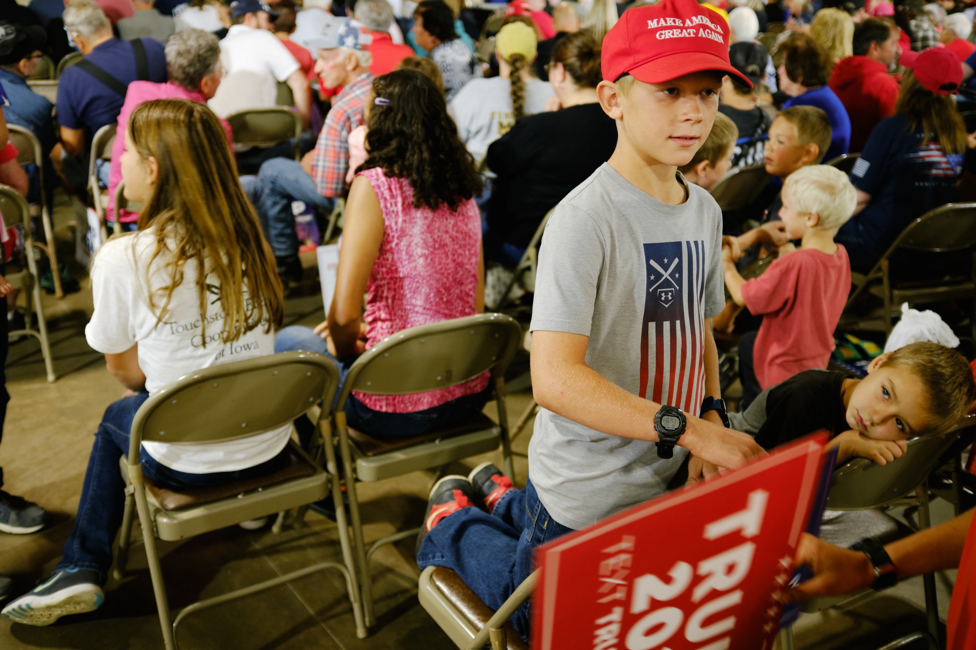  Children hold signs at the Team Trump Iowa Commit to Caucus Event at the Jackson County Fairgrounds in Maquoketa, IA on Sept. 20, 2023. (Mustafa Hussain for the New York Times) 